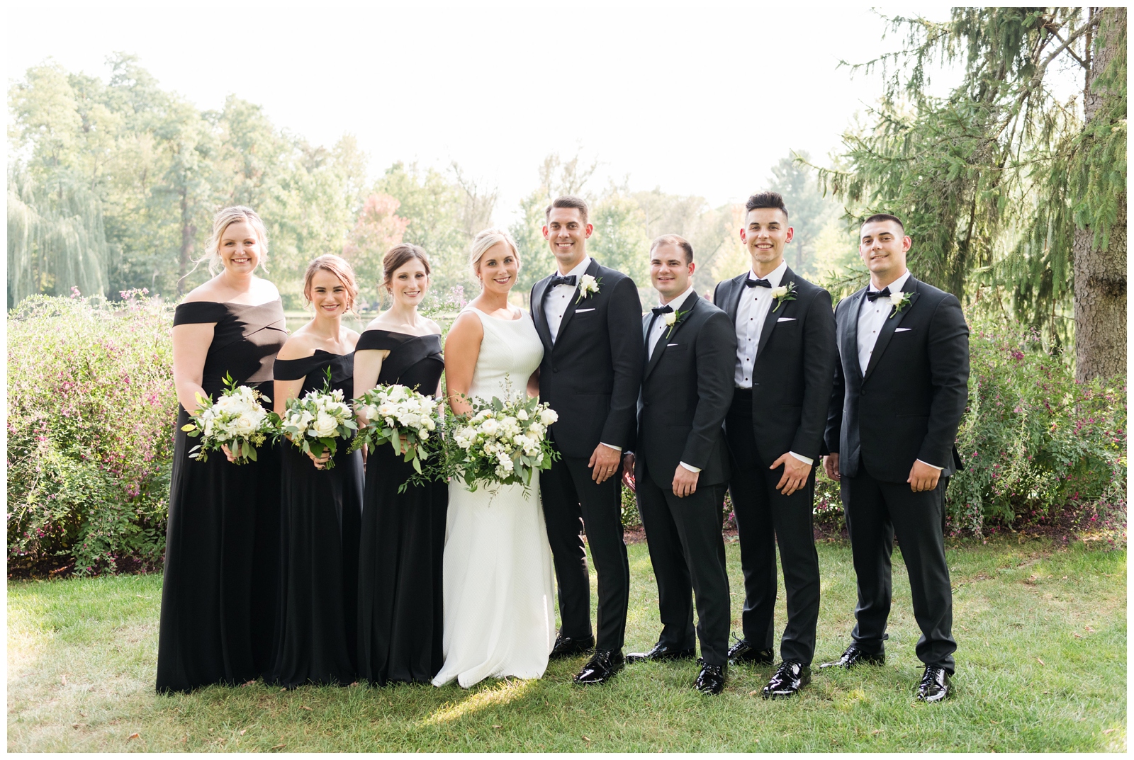 bridal party of six poses with bride and groom during elegant Italian wedding at Gervasi Vineyard
