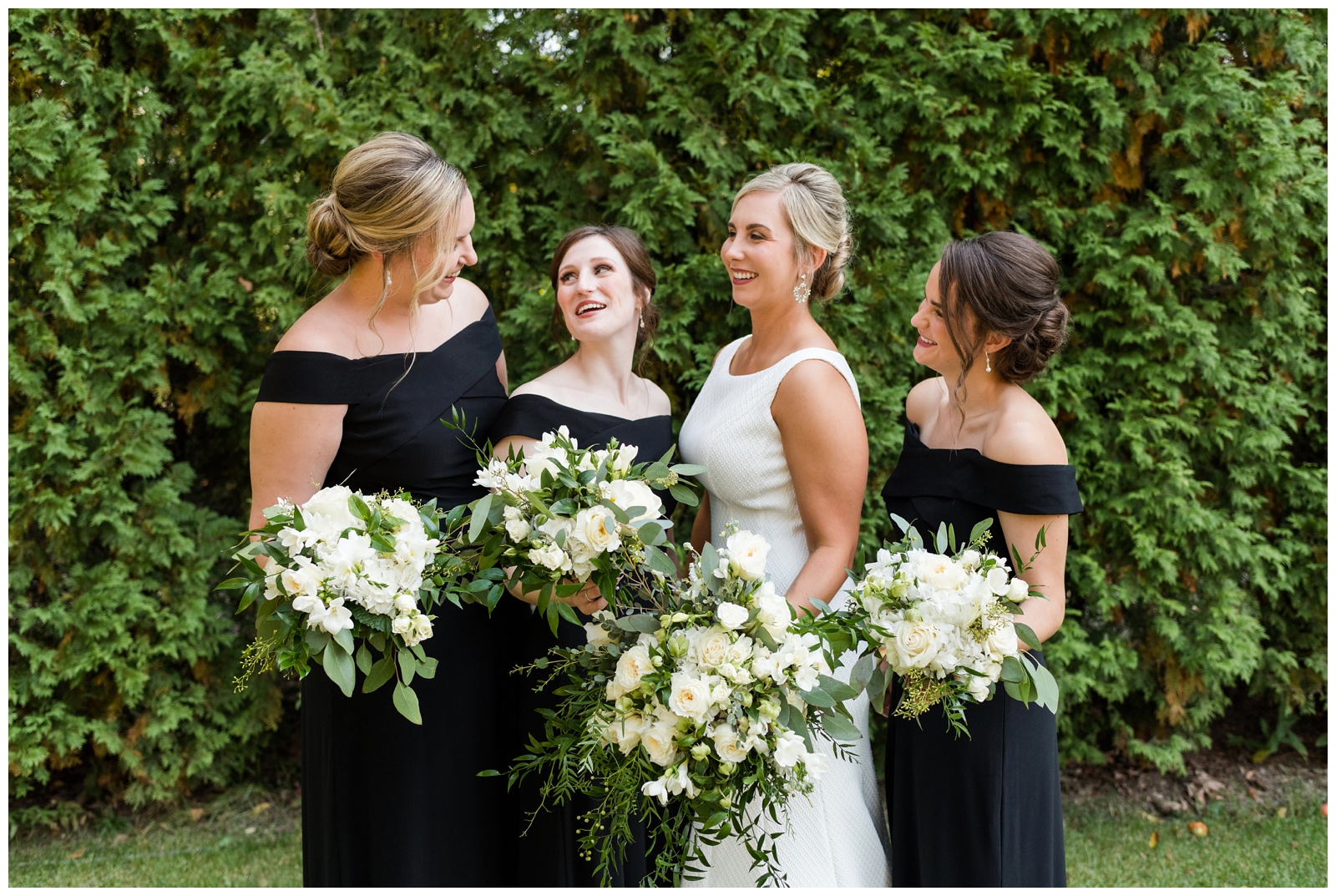 bridesmaids in off-the-shoulder black dresses with updos pose for OH wedding photographer Pipers Photography