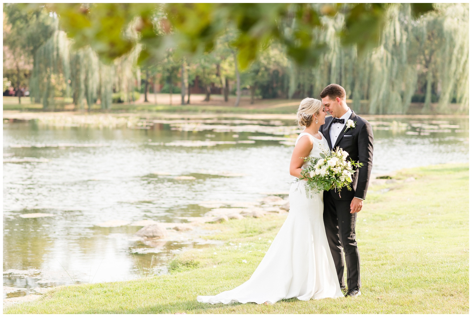 portrait of bride and groom talking next to pond at Gervasi Vineyard