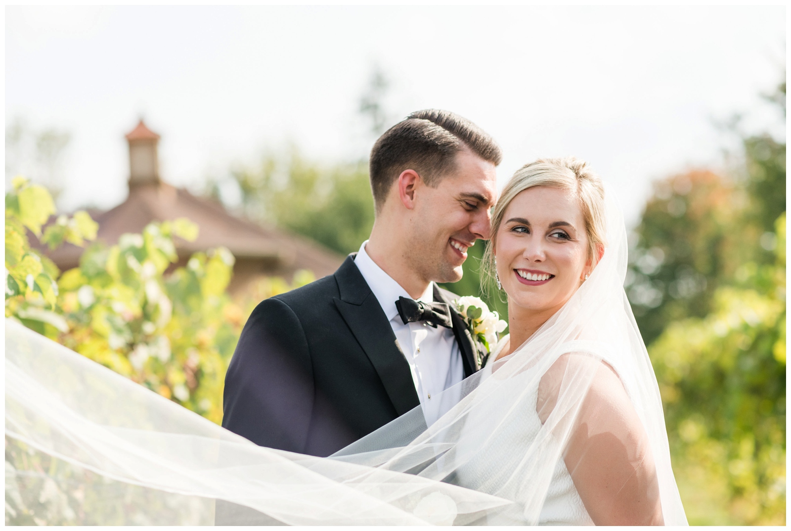 close up portrait of bride and groom on wedding day with Gervasi Vineyard building in background