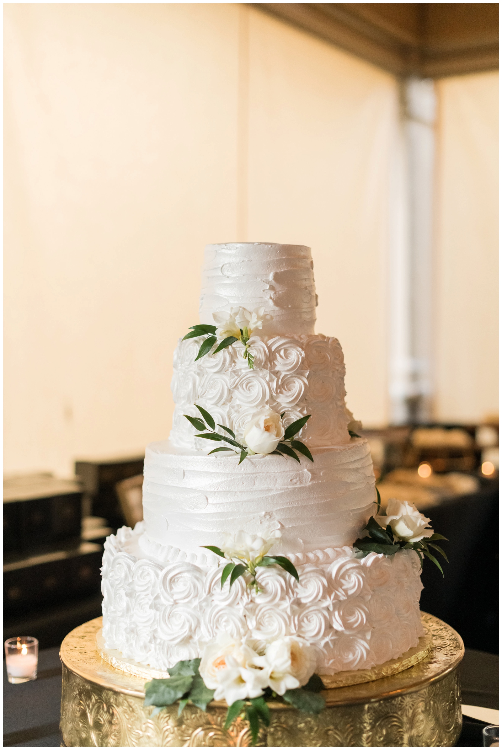 four tiered wedding cake with ivory rose accents photographed by Pipers Photography