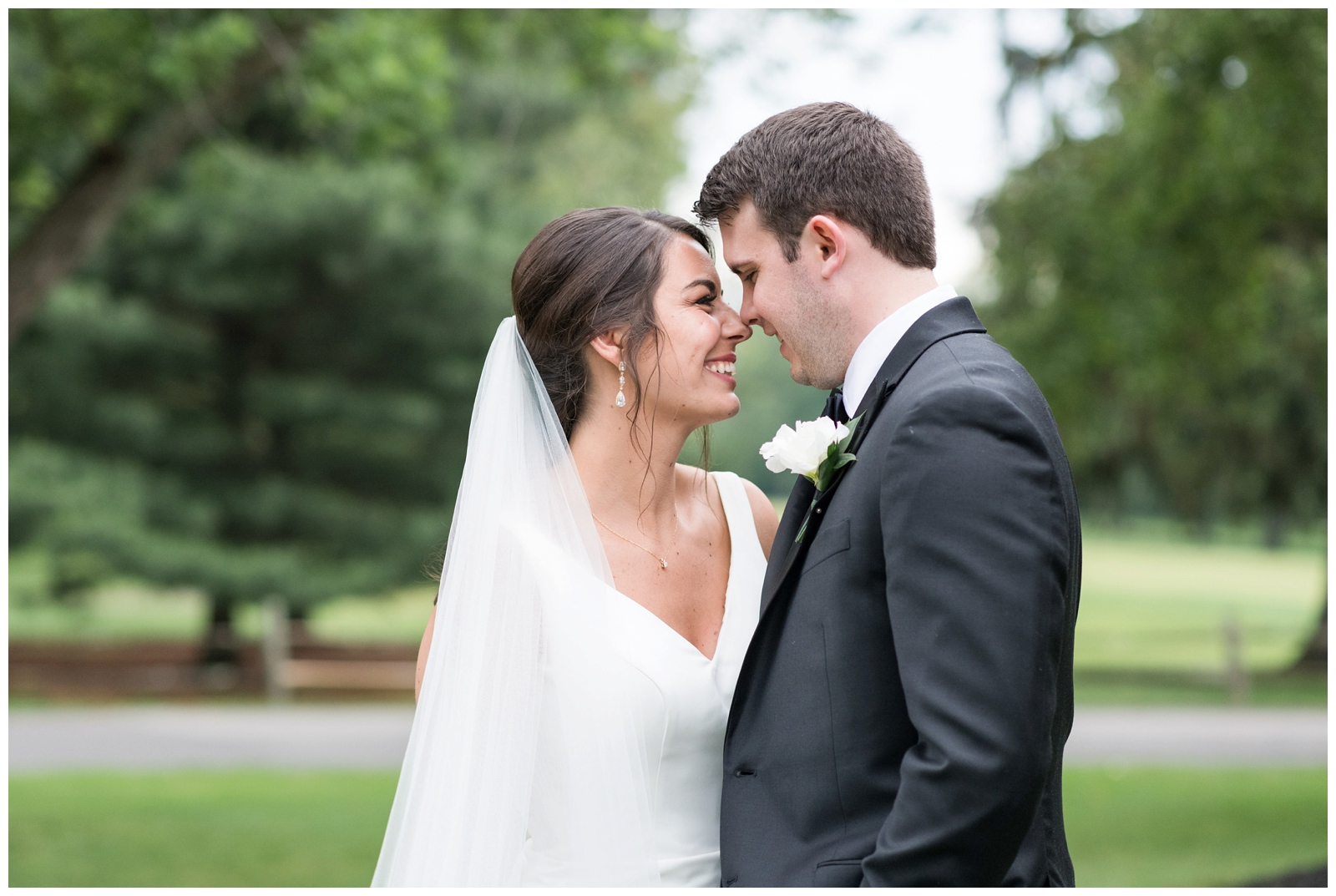 bride and groom nuzzle noses during wedding portraits at Brookside Golf and Country Club 