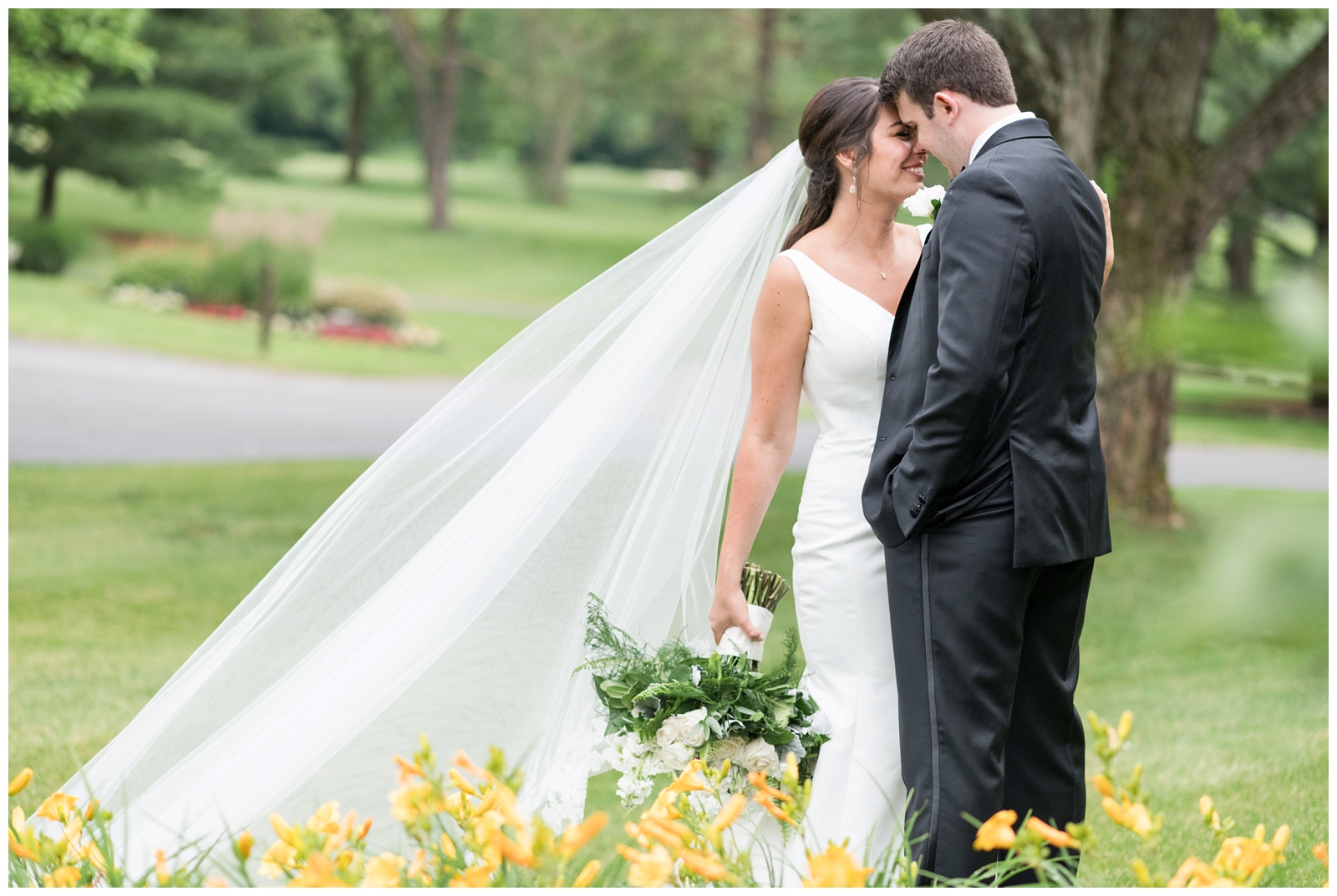 bride and groom look at each other while standing near yellow flowers at Brookside Golf and Country Club 