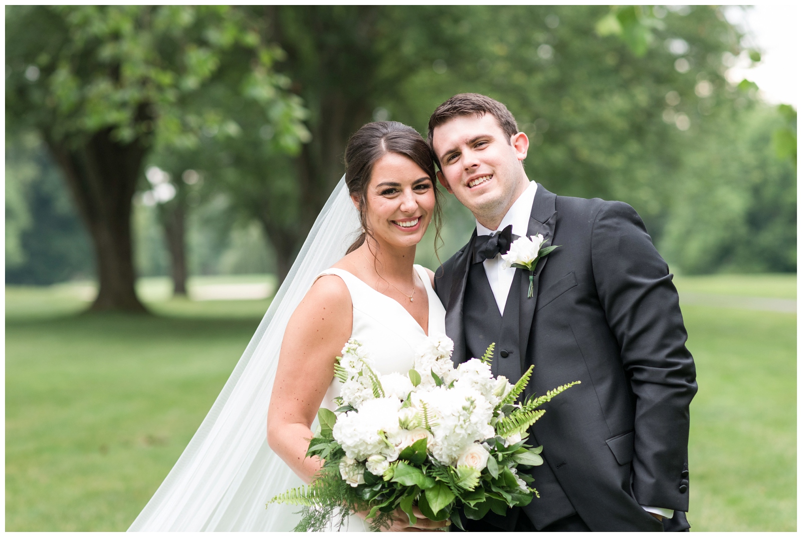bride and groom smile at Pipers Photography during Columbus OH wedding portraits