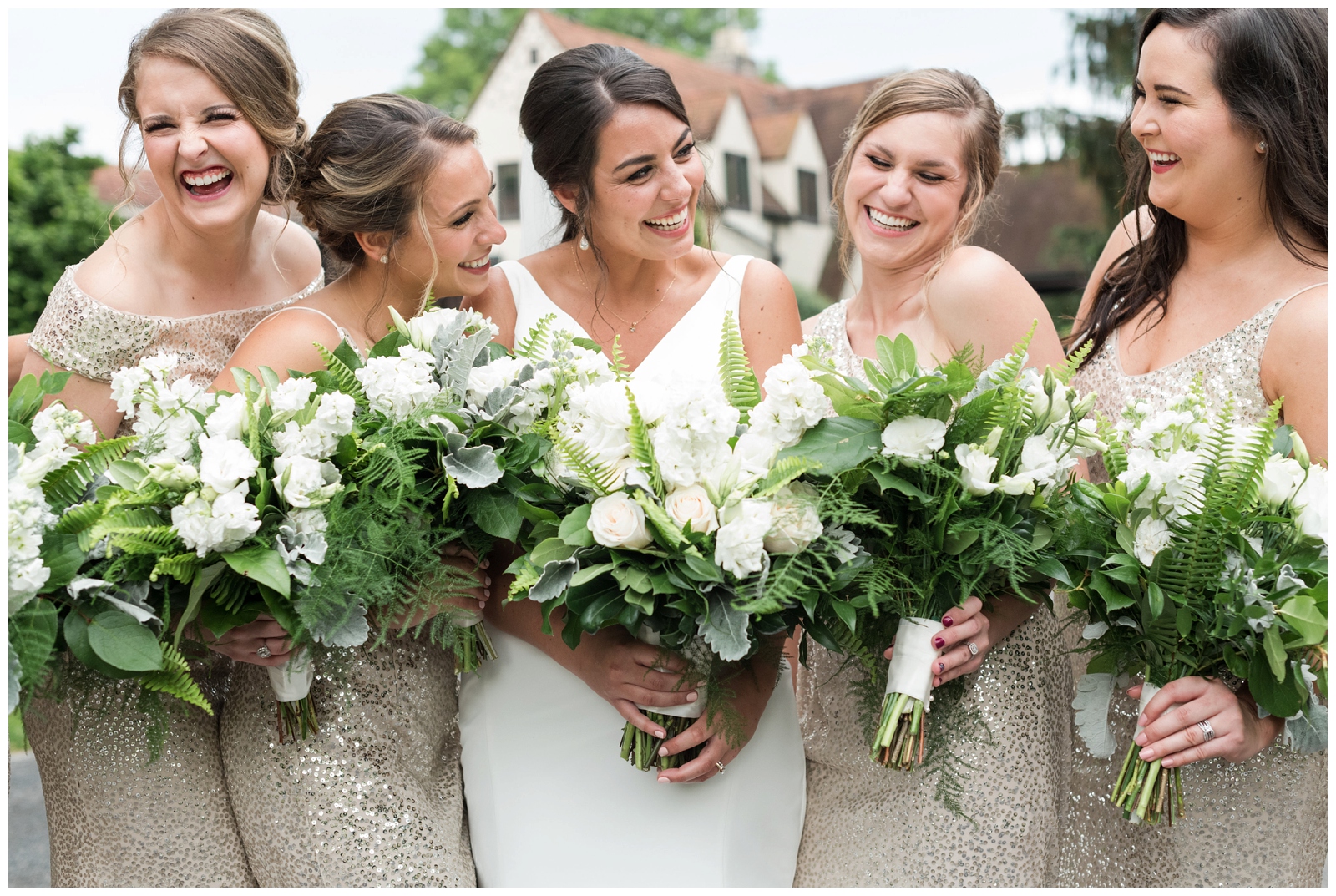 bride laughs with bridesmaids in gold gowns during Columbus OH wedding day