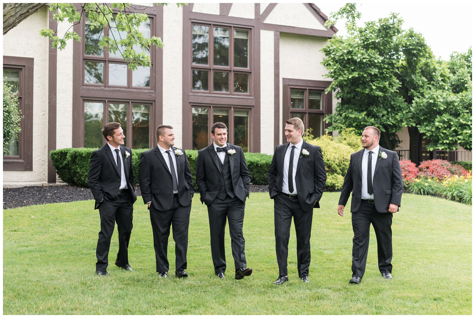 groom talks with groomsmen on the grounds of Brookside Golf and Country Club 