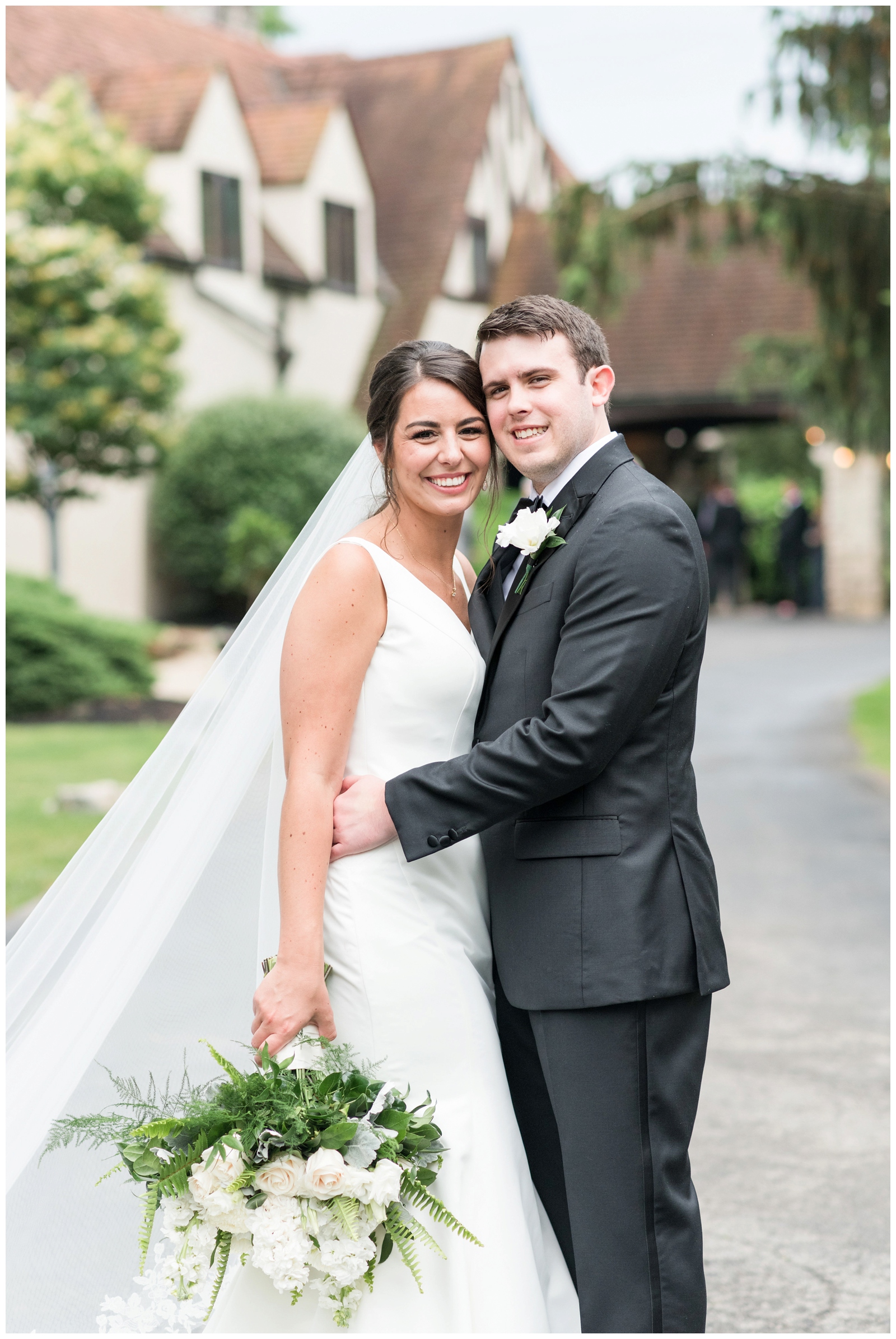 bride and groom embrace outside Brookside Golf and Country Club 