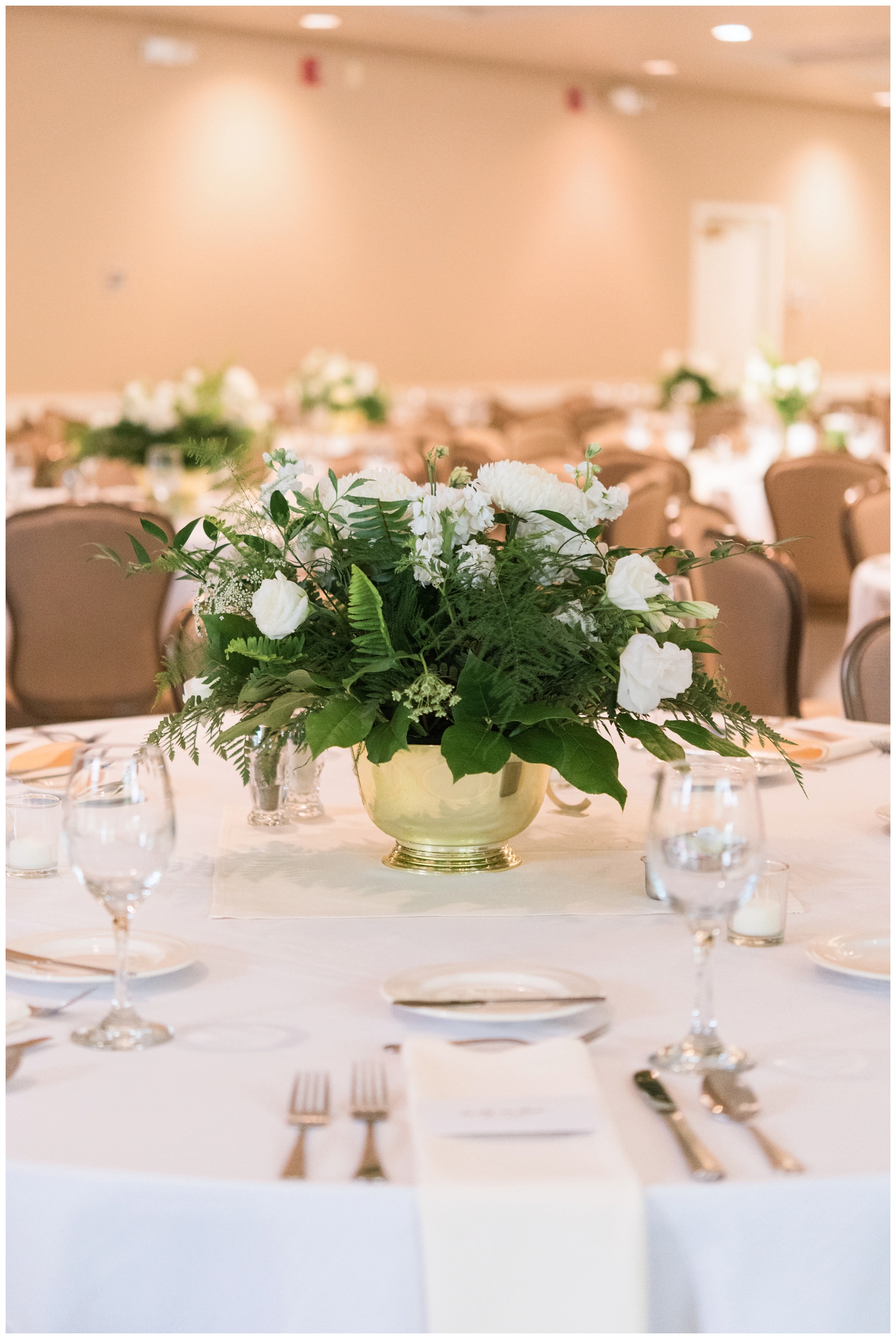 white and green floral centerpieces in gold containers at Brookside Golf and Country Club 