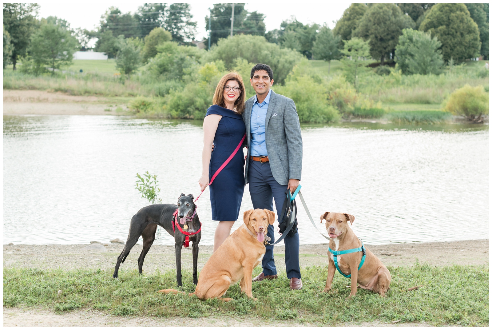 bride and groom pose with their three dogs at Hoover Reservoir during engagement portraits