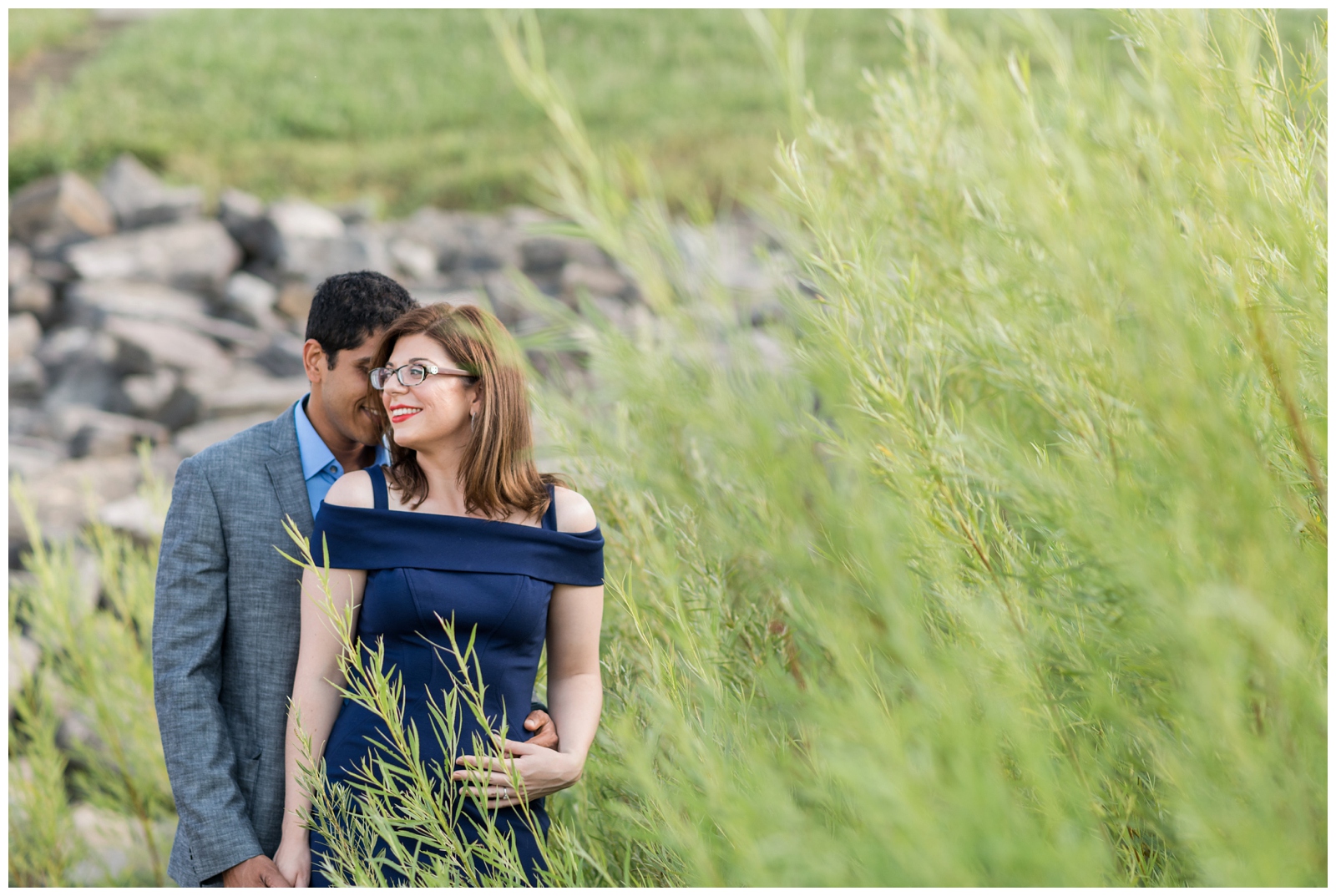groom embraces bride during engagement portraits along Hoover Reservoir with Pipers Photography