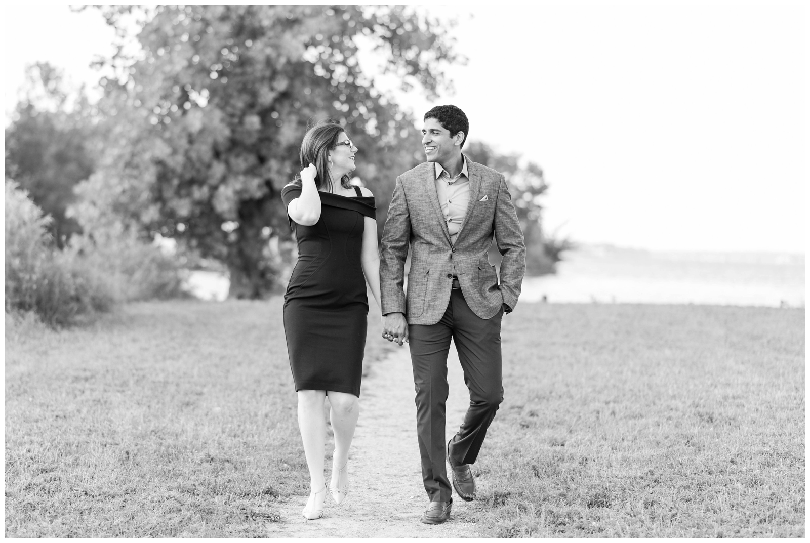 black and white portrait of bride and groom talking and walking during Ohio engagement session by Pipers Photography