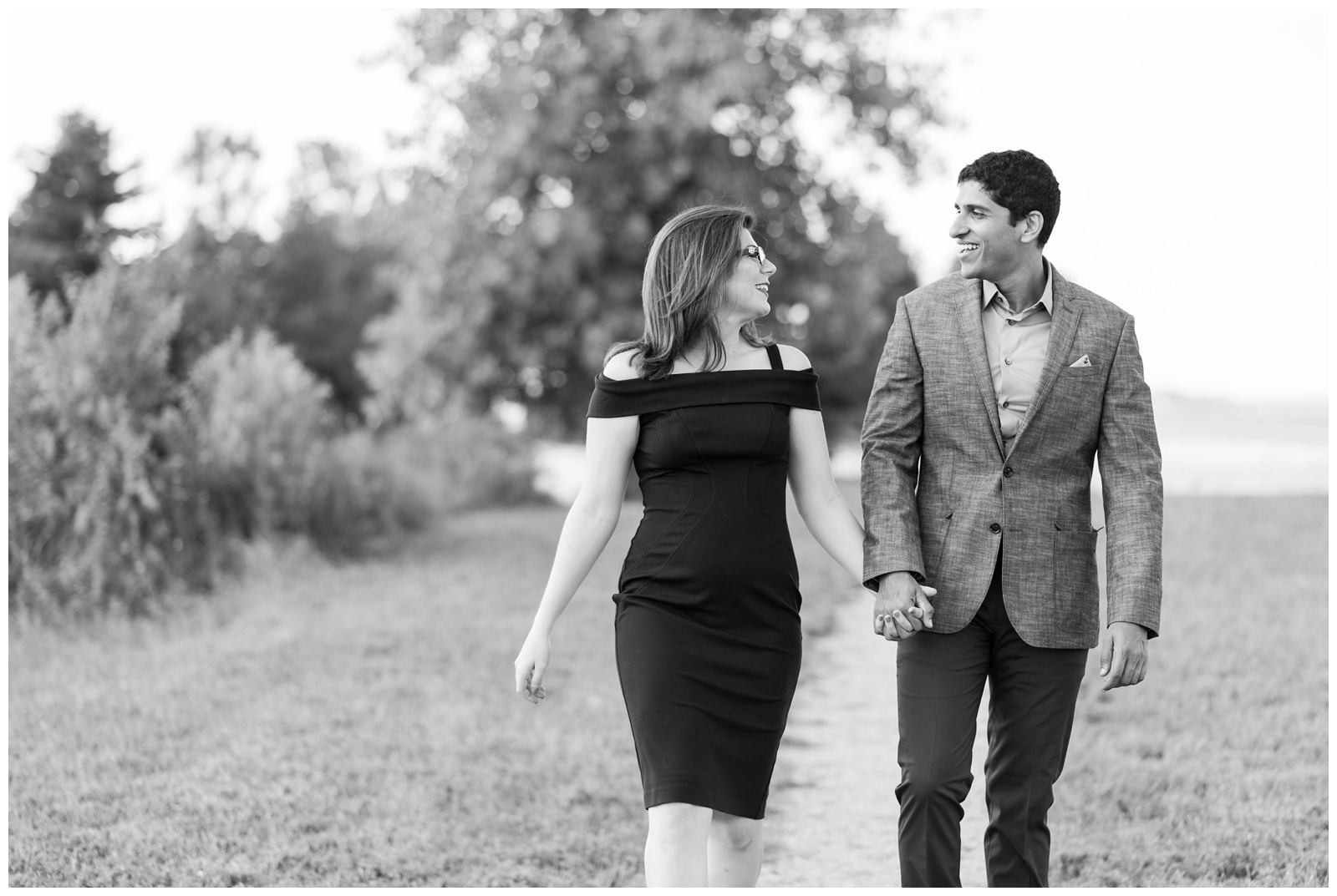 couple walks and talks holding hands facing photographer during Ohio engagement session