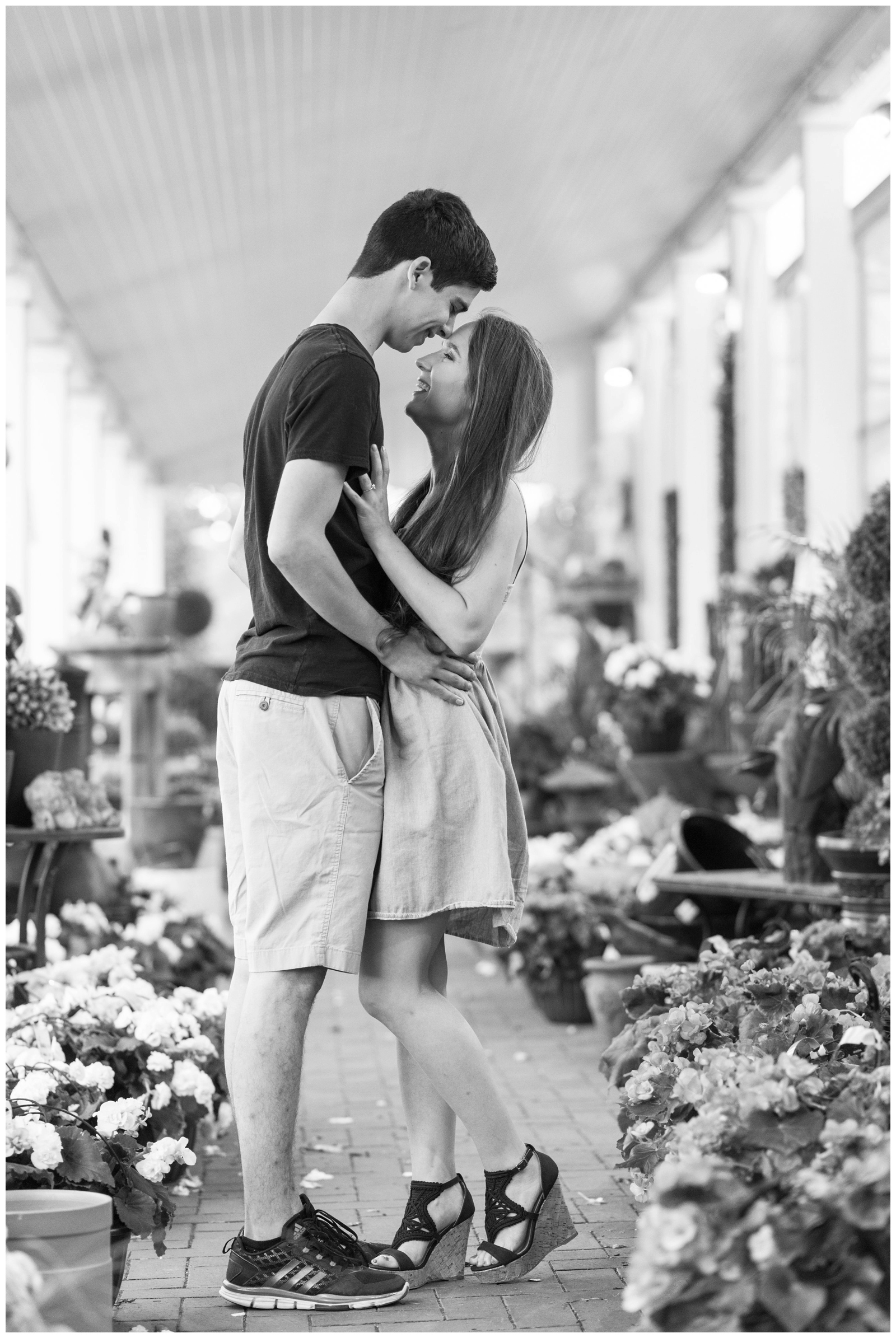 bride and groom hold each other on porch of Oakland Nursery in New Albany Ohio engagement session