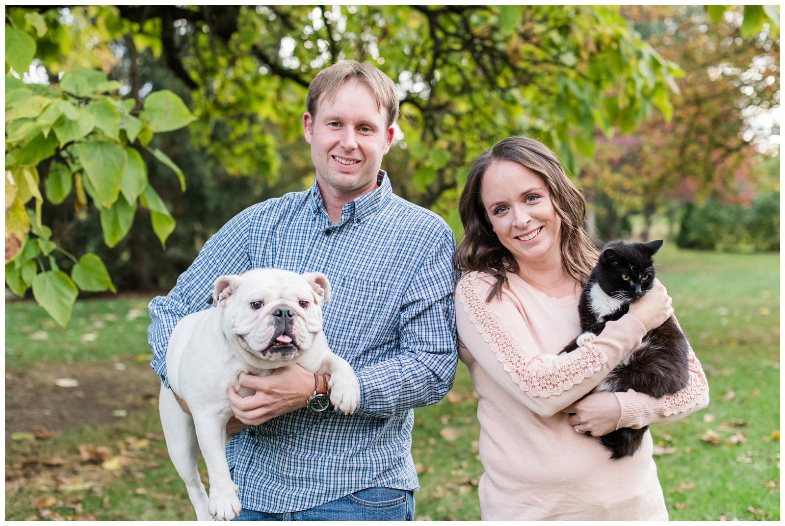 engaged couple holds their dog and cat during engagement portraits in Columbus OH
