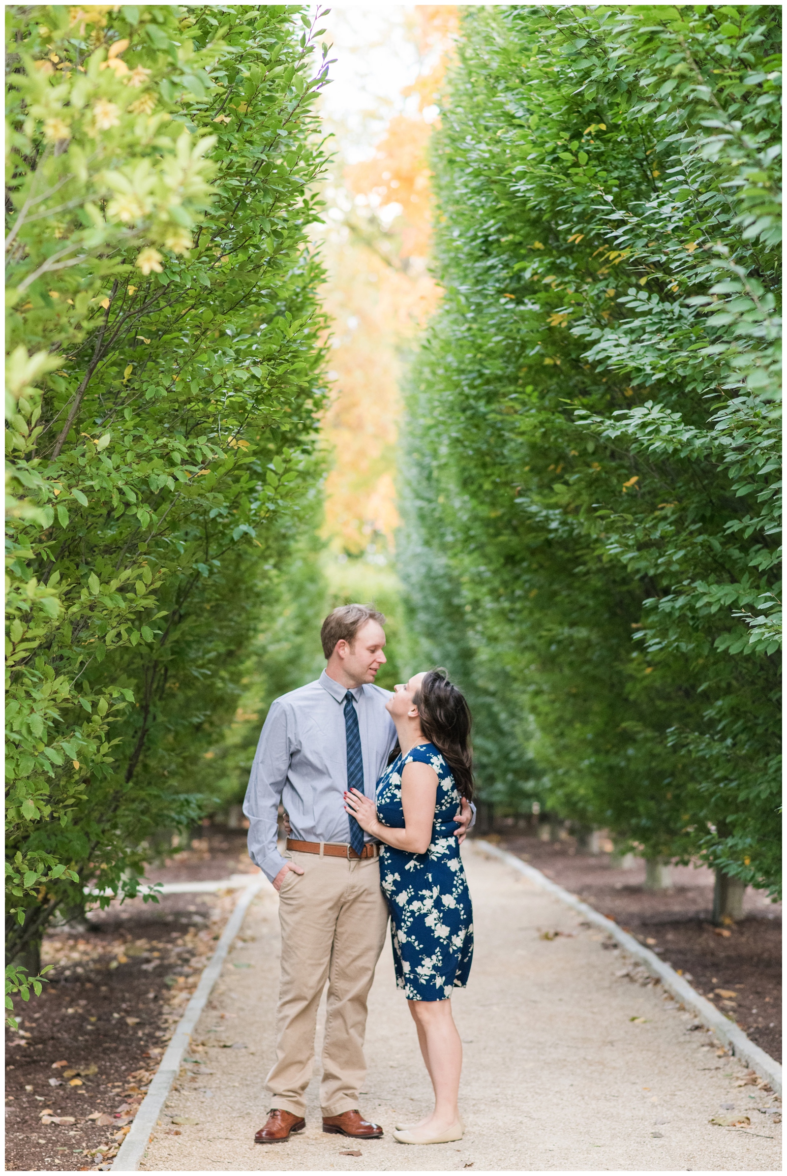 Franklin Park Conservatory engagement portraits with bride in blue dress smiling at groom in blue shirt