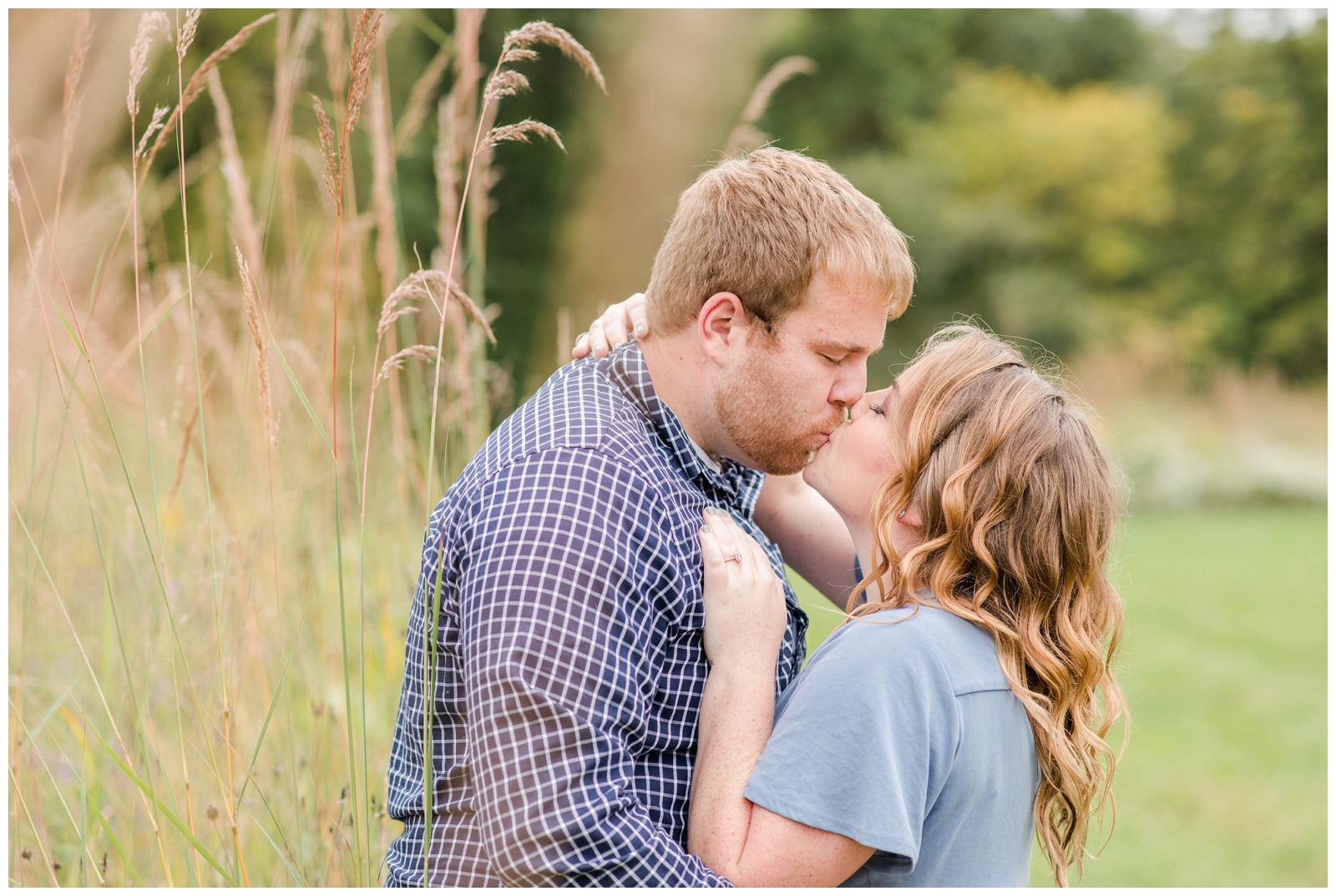bride and groom kiss next to field of tall grass at Dawes Arboretum