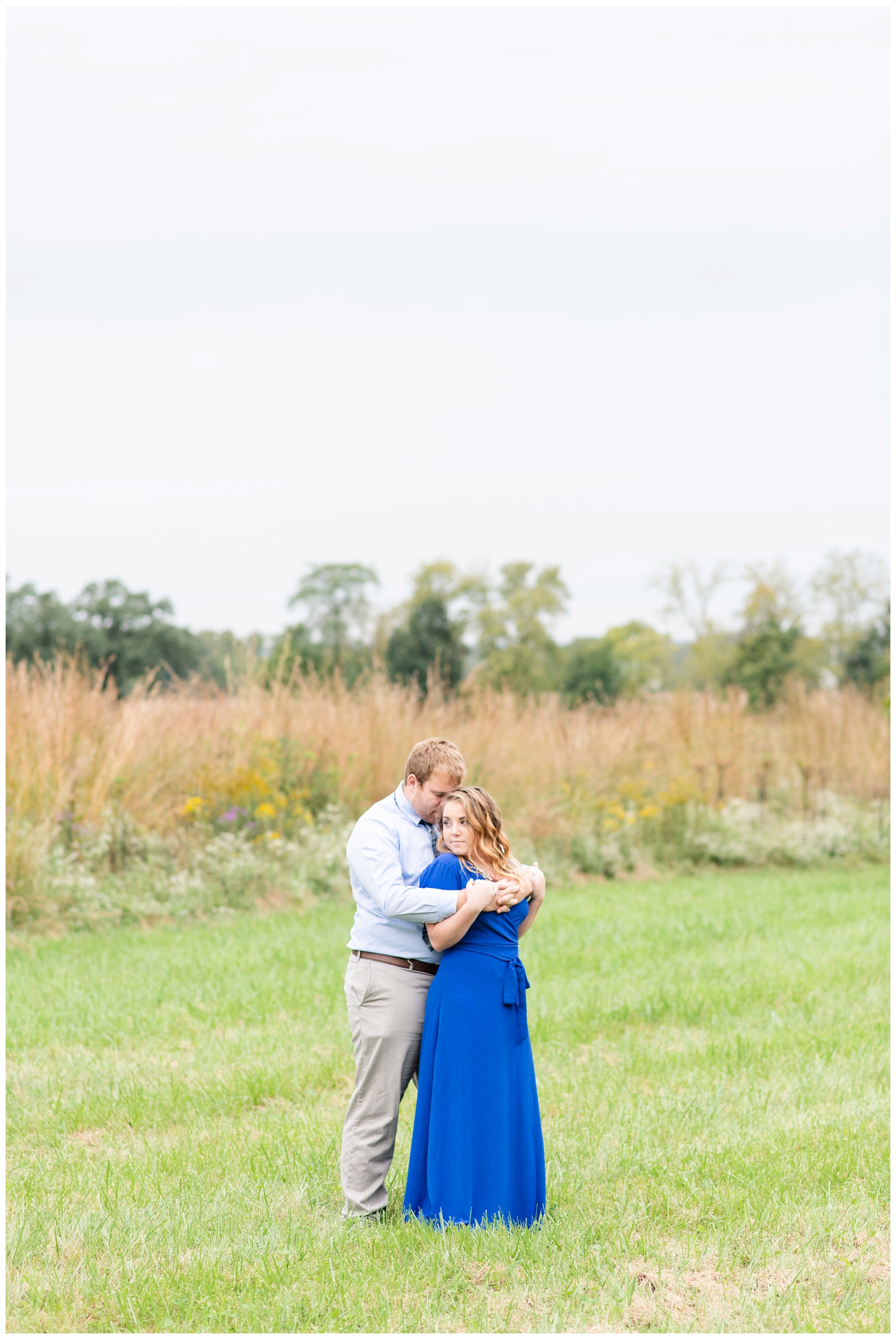 bride and groom stand in field at Dawes Arboretum in Newark OH