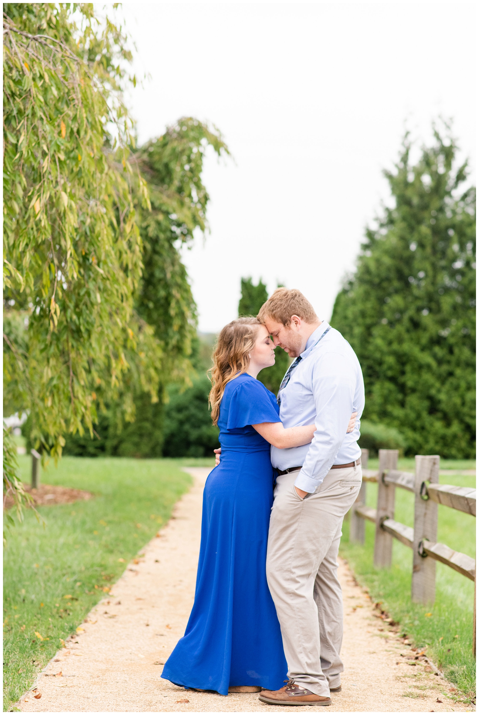bride and groom touch noses during engagement session portraits at Dawes Arboretum