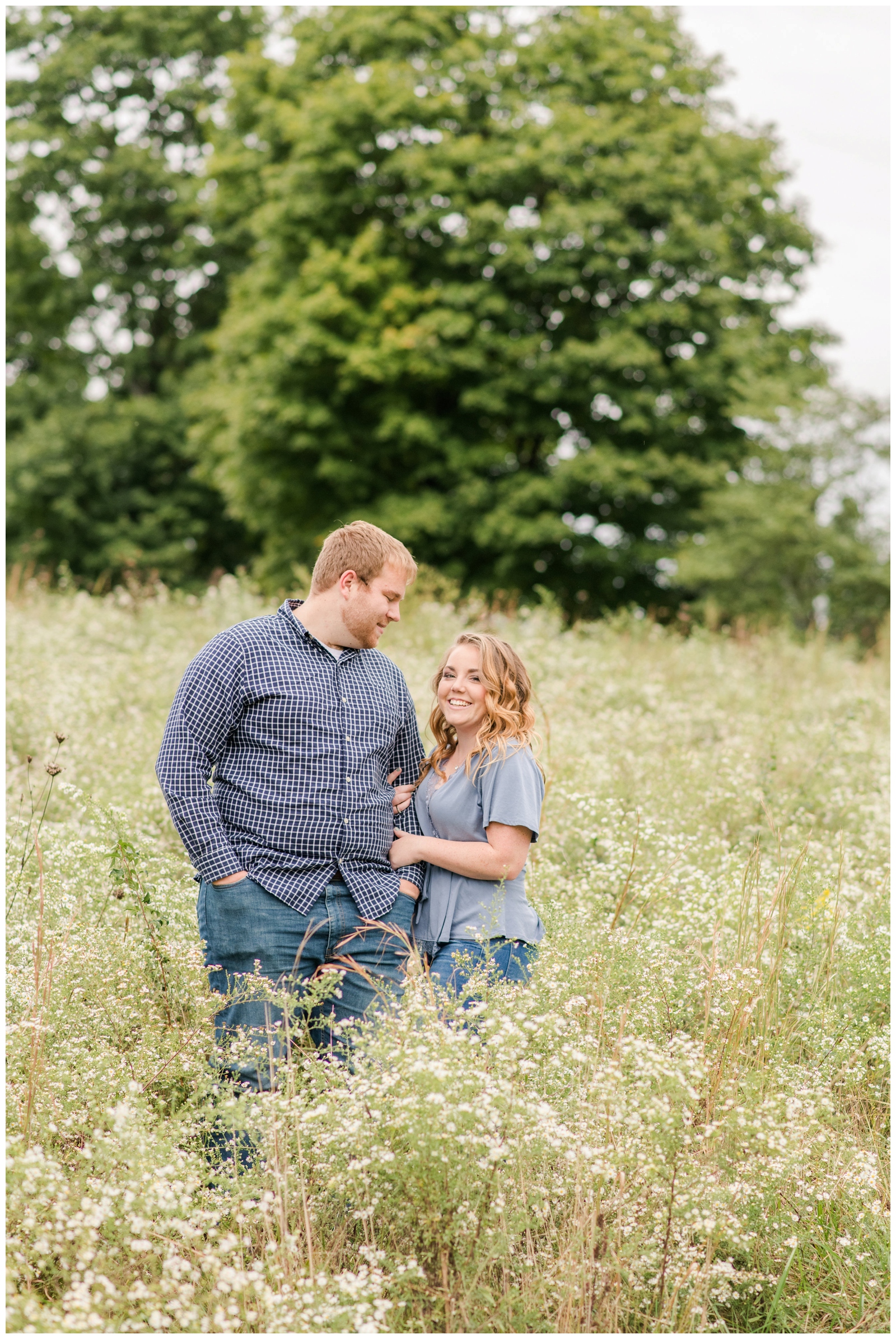 Newark OH couple in the field at Dawes Arboretum for engagement portraits