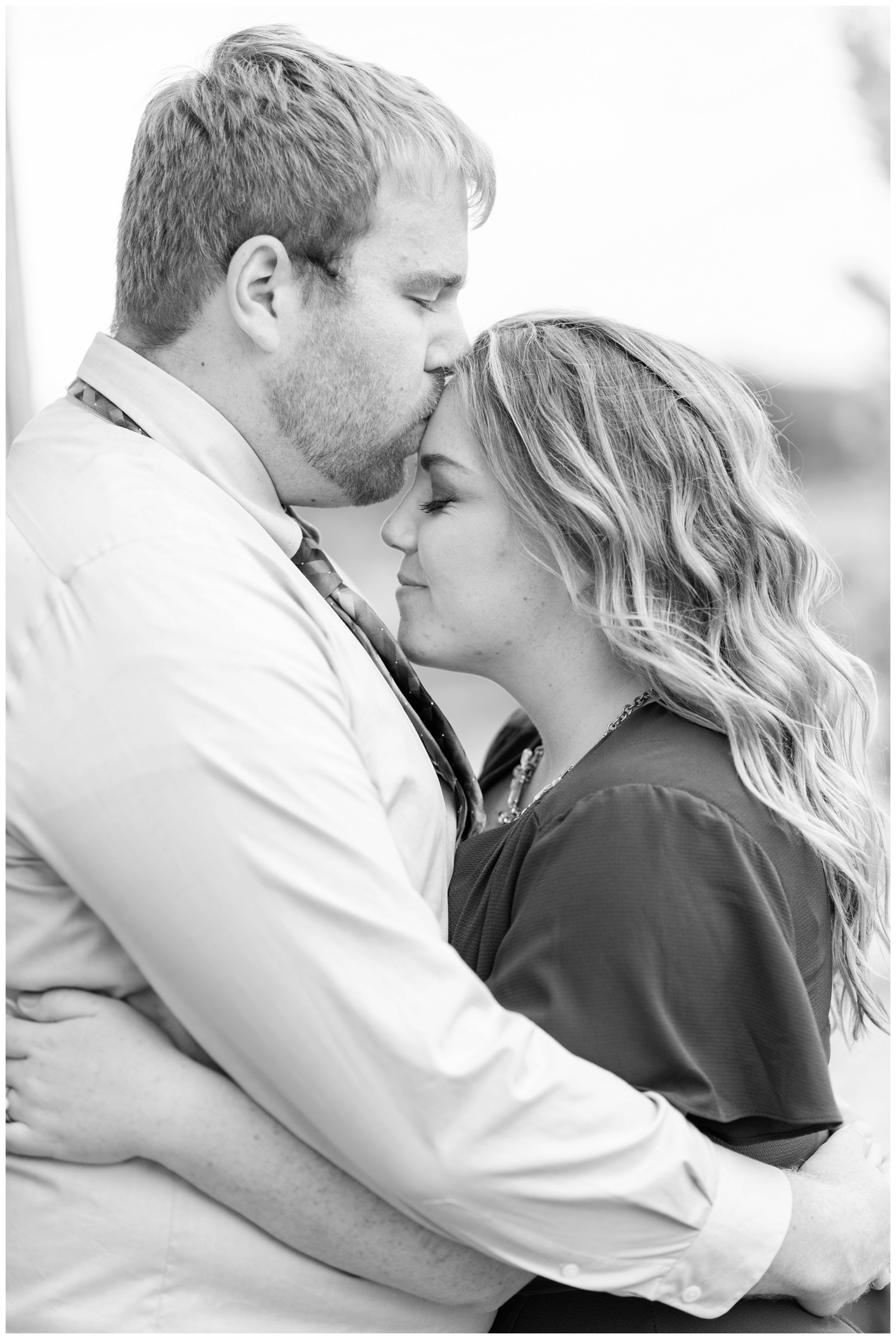 black and white close up photo of groom-to-be kissing fiancee during engagement portraits at Dawes Arboretum