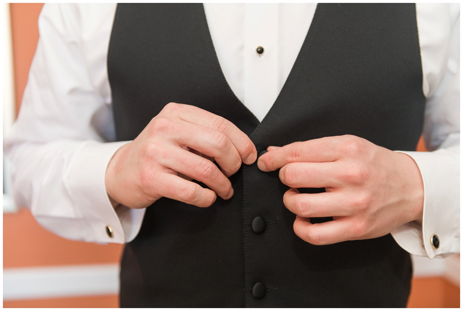 groom adjusts vest button before Columbus OH wedding
