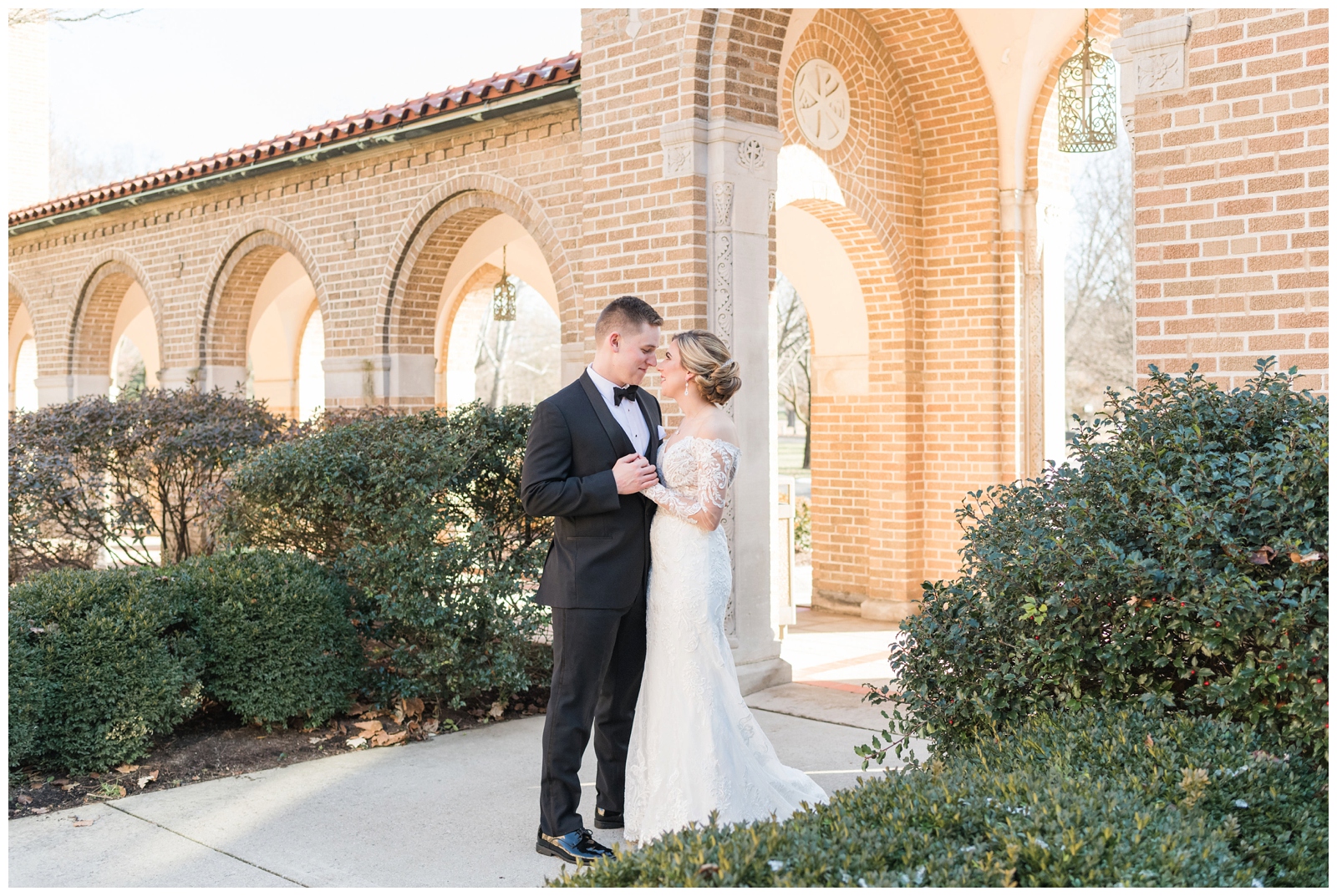 bride and groom look at each other during winter wedding portraits at St. Charles Preparatory School