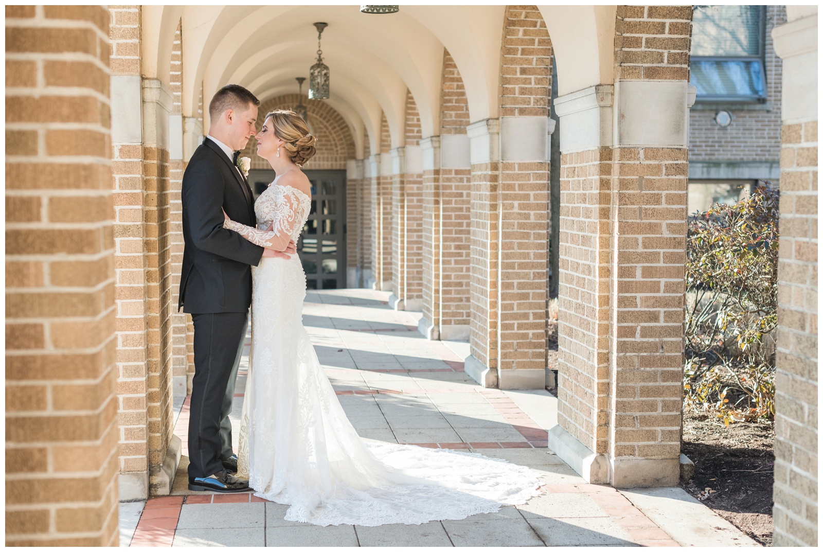 bride and groom stand nose to nose on winter wedding day at St. Charles Preparatory School