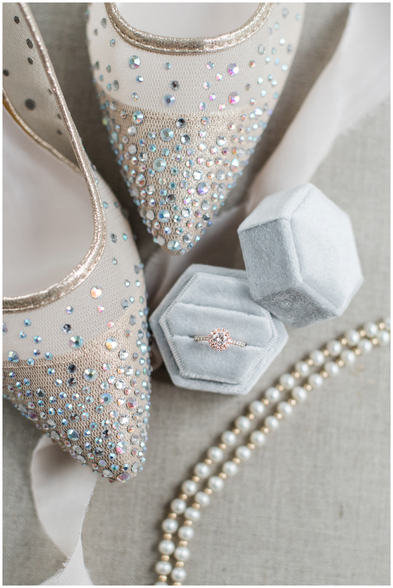 bride's shoes with jewel details and wedding ring in pastel blue box