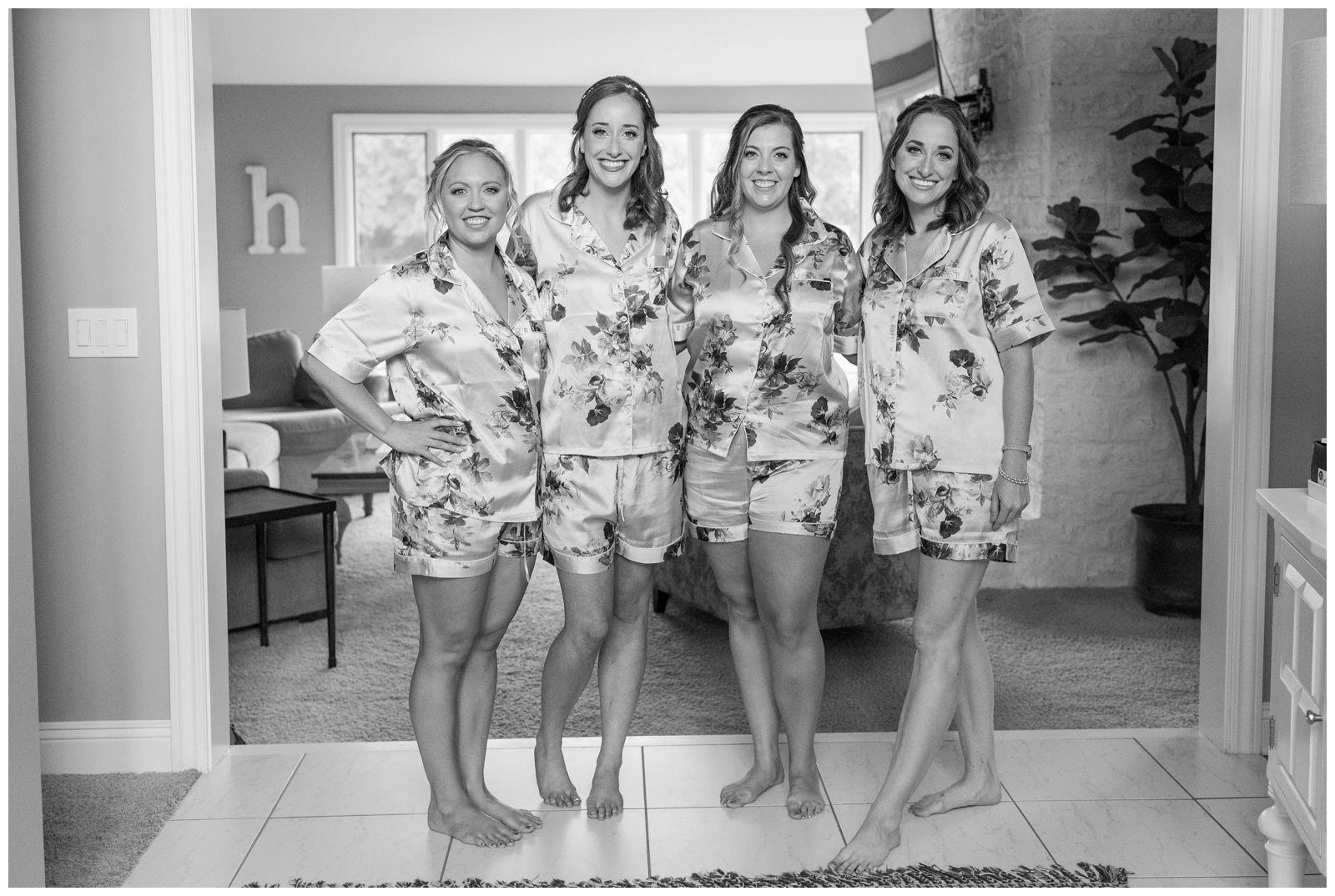 bride with four bridesmaids in floral pajamas before Ohio wedding day