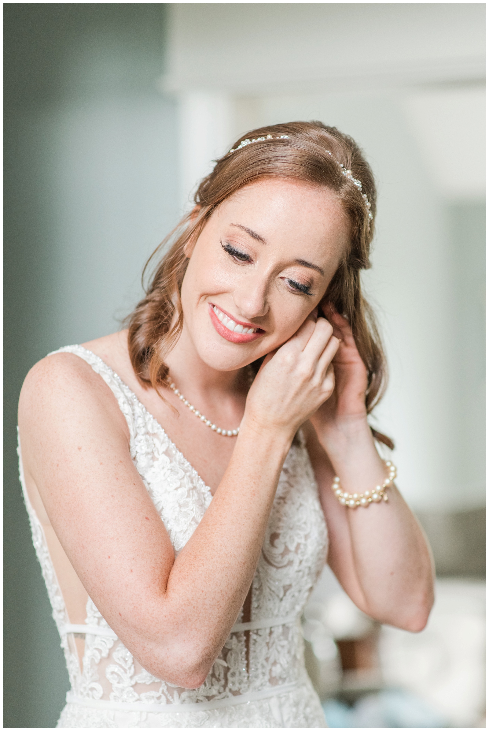 Ohio bride adjusts earrings before wedding day