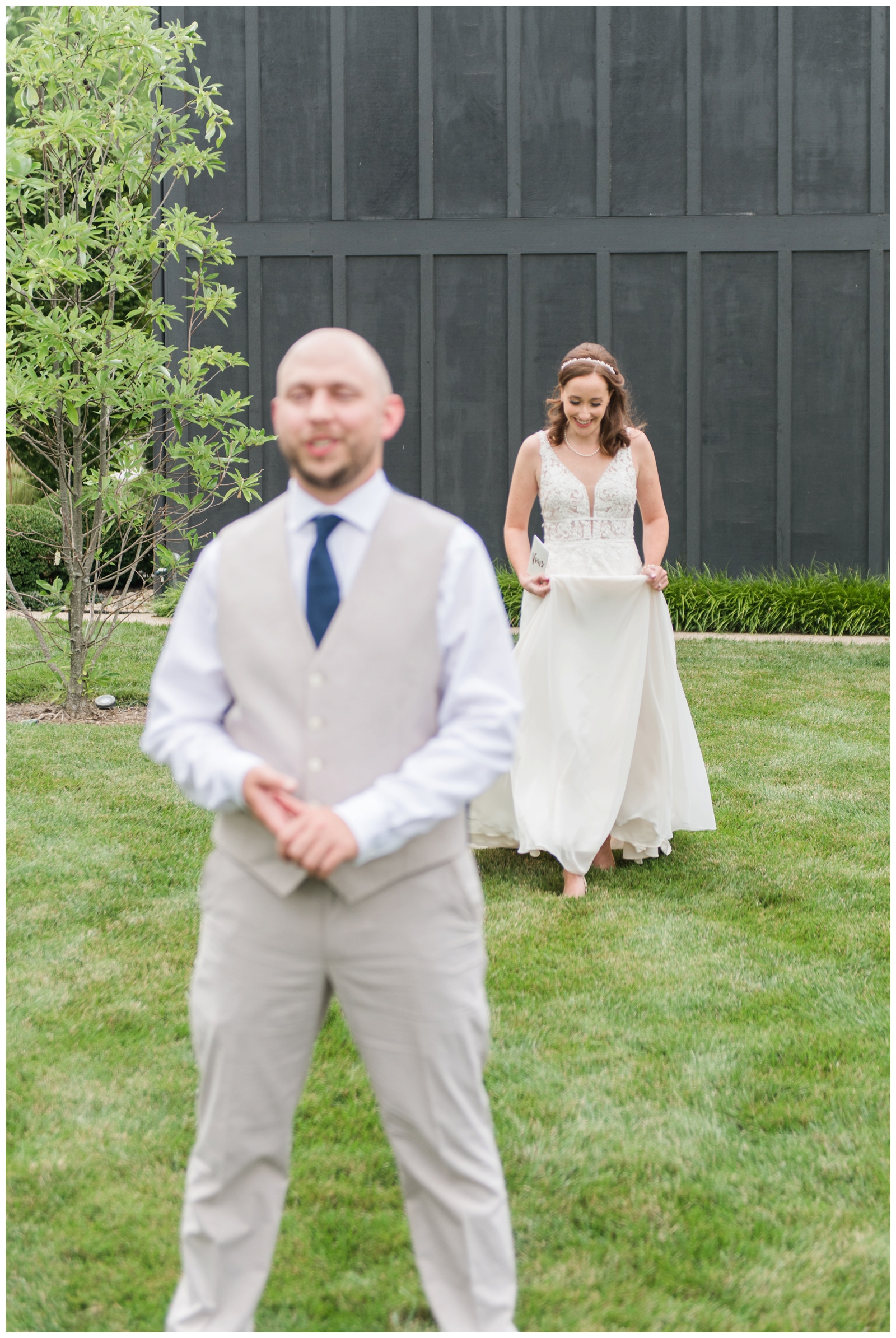 bride walks up to groom during first look at Oak Grove Jorgensen Farms