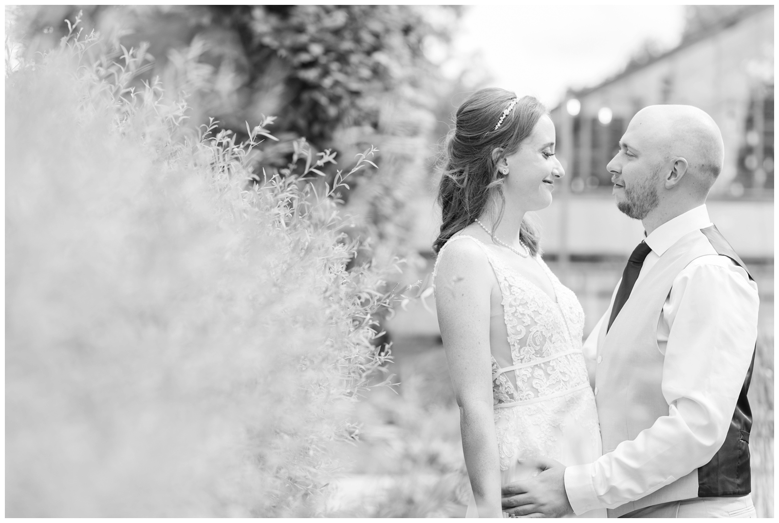 black and white portrait of bride and groom looking at each other at Oak Grove Jorgensen Farms