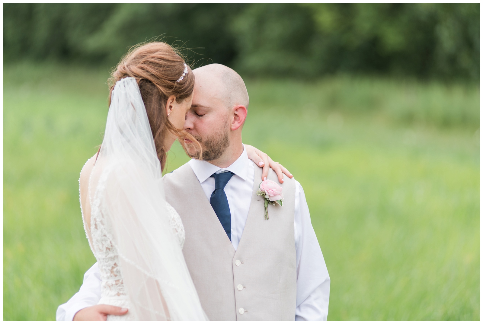 bride and groom touch noses during portraits in the summer at Oak Grove Jorgensen Farms