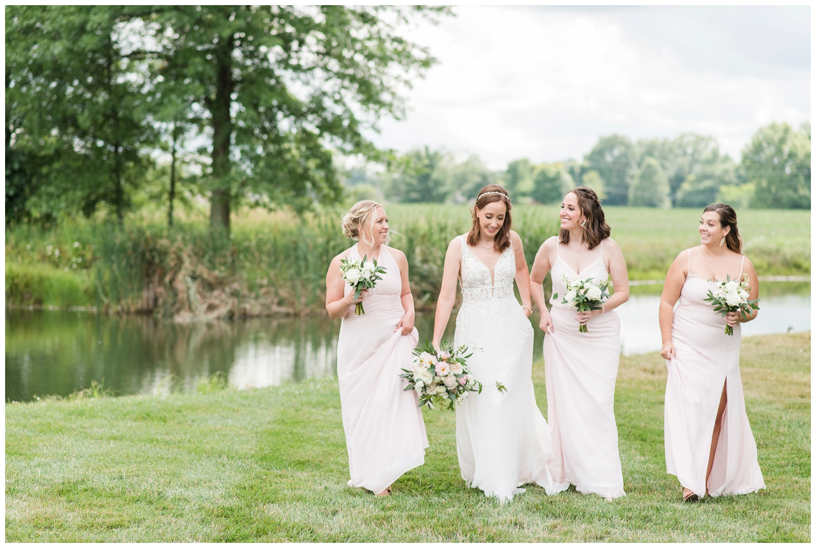 bride and bridesmaids in pale pink dresses walk for Ohio wedding