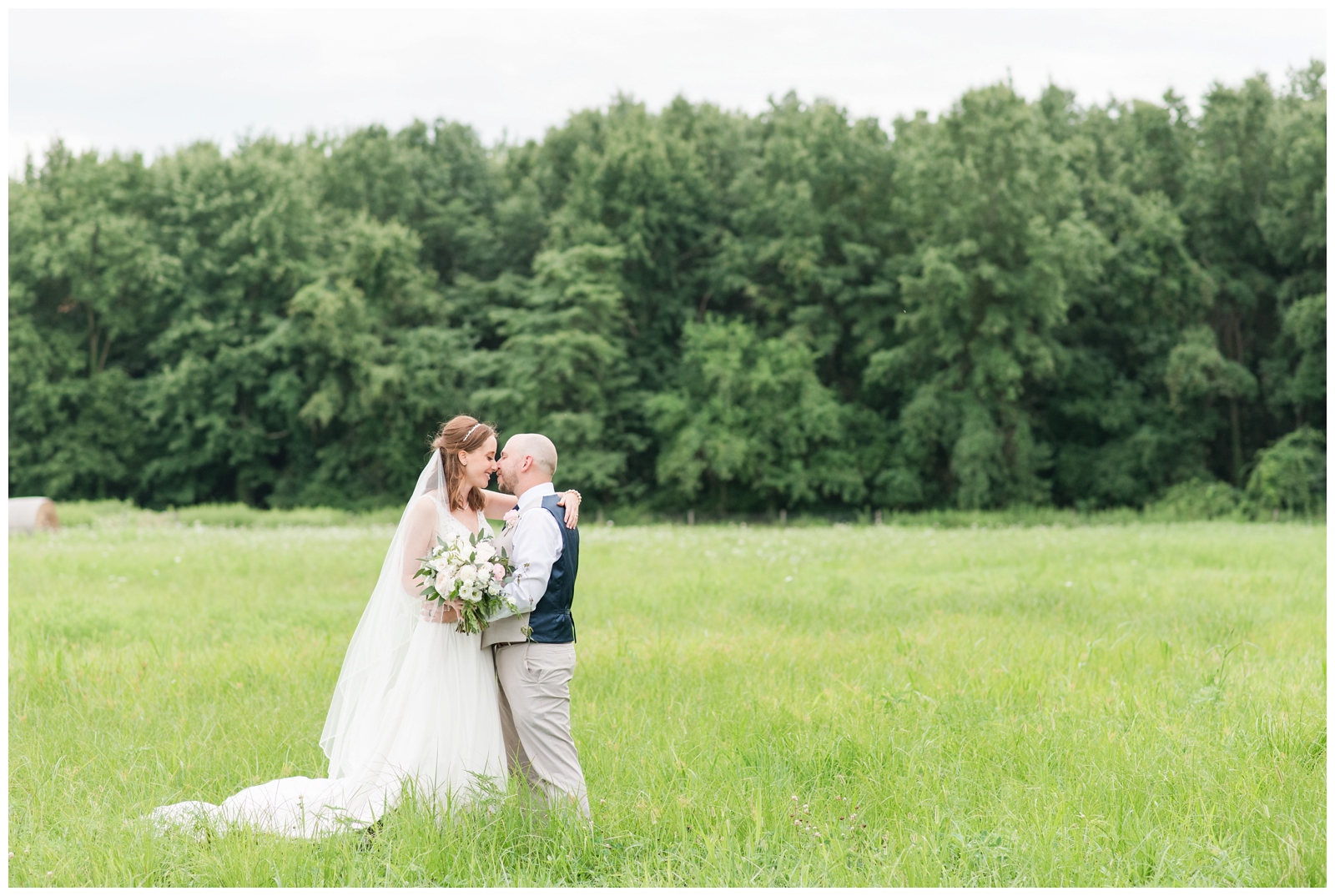 bride and groom stand nose to nose in Oak Grove Jorgensen Farms field