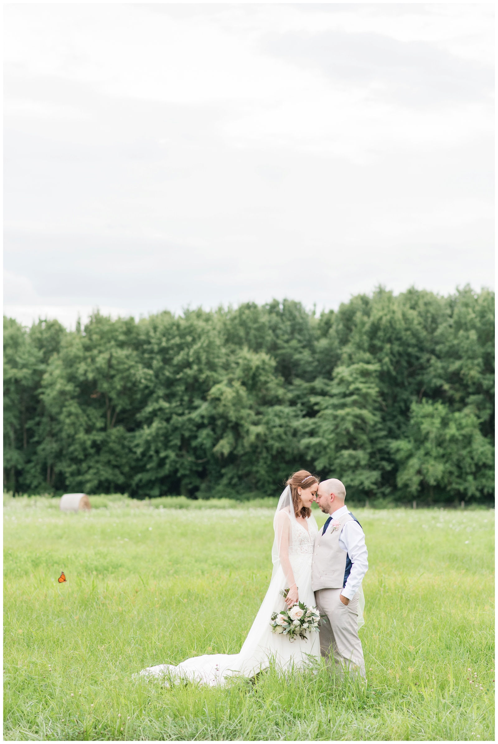 bride and groom touch noses during portraits in field at Oak Grove Jorgensen Farms
