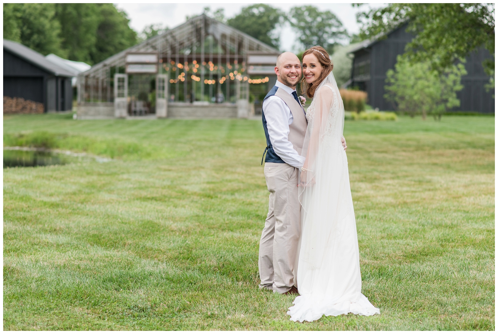 Oak Grove Jorgensen Farms wedding portraits of bride and groom by greenhouse