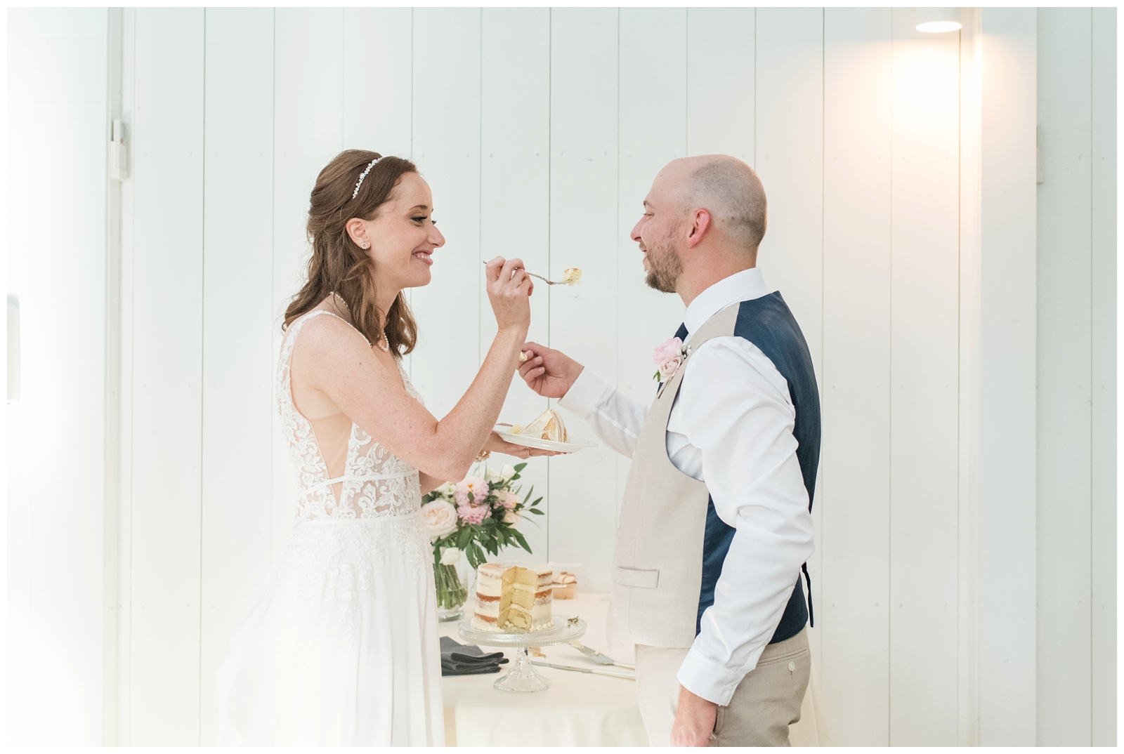 bride and groom feed each other cake during Ohio wedding outdoor cocktail hour