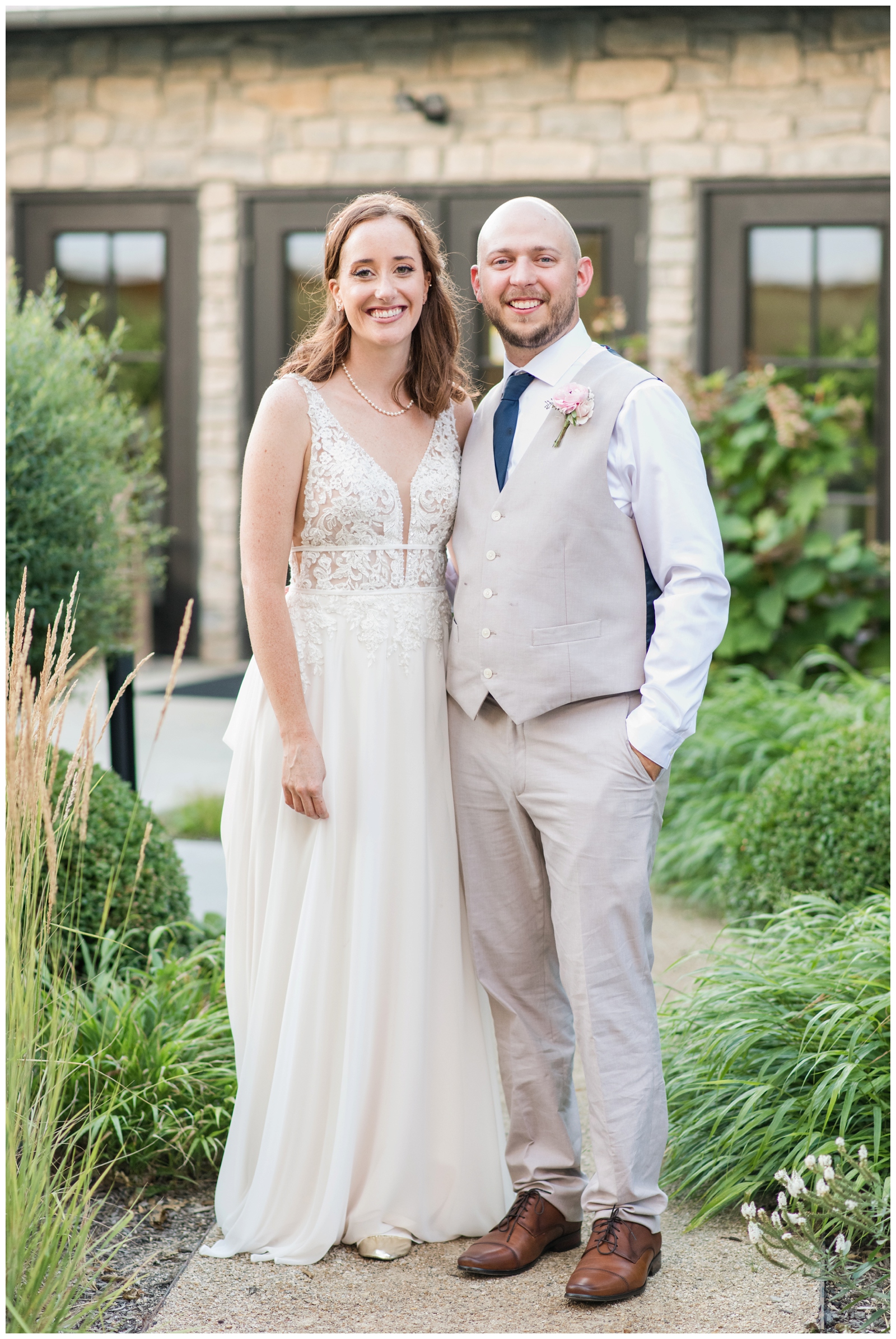 bride and groom stand in front of Oak Grove Jorgensen Farms