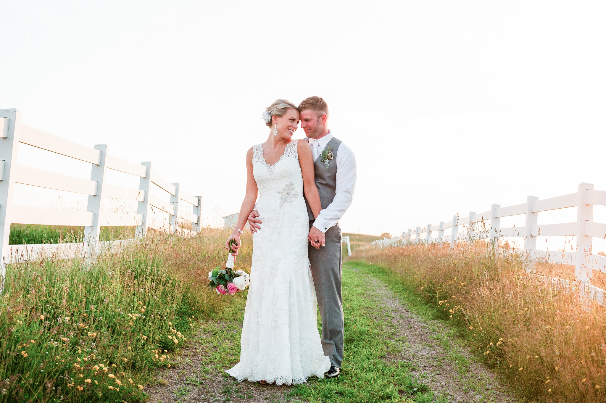 bride and groom standing in a field at a barn wedding venue ohio