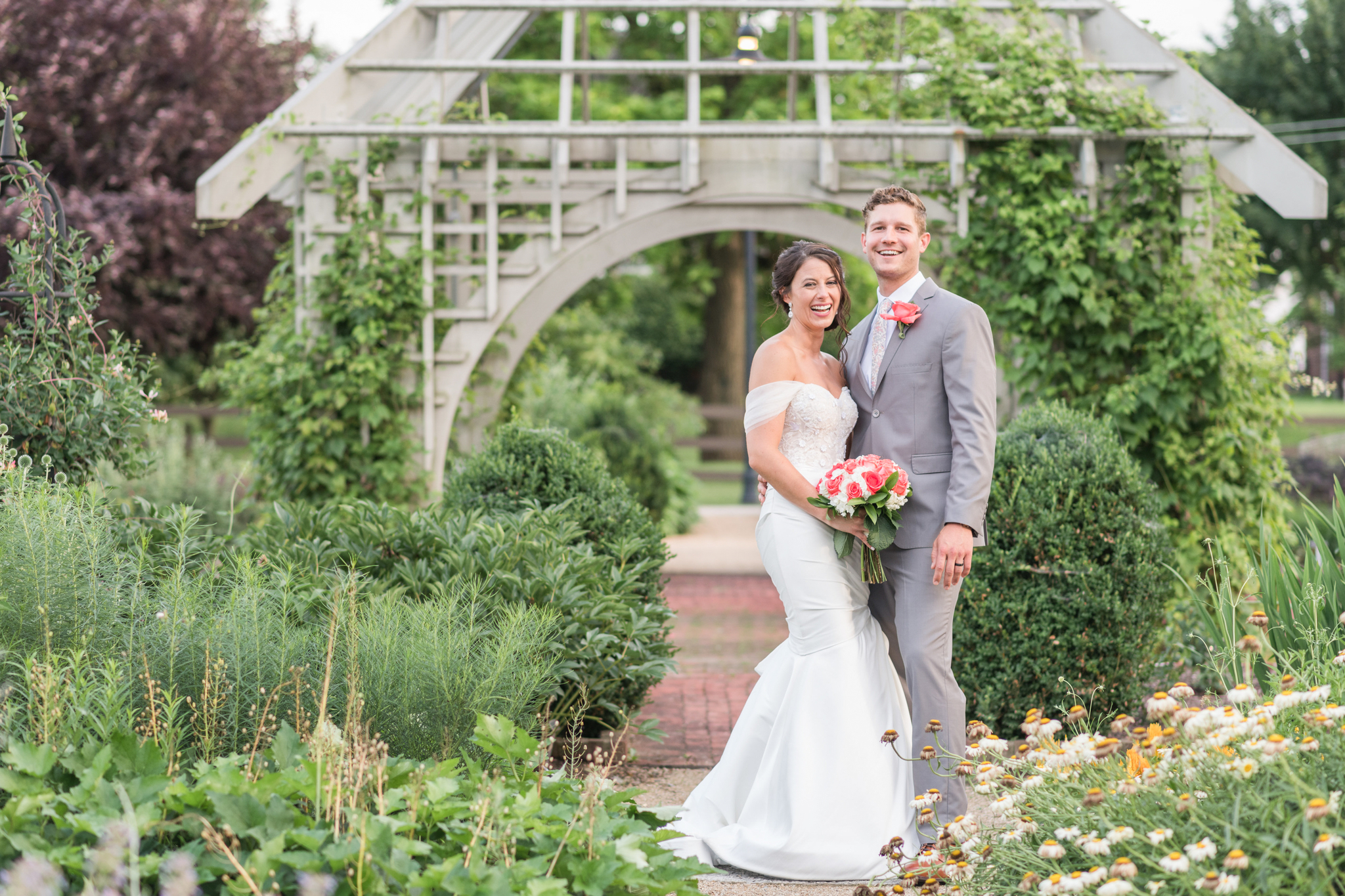 bride and groom standing in a garden at Wells Barn