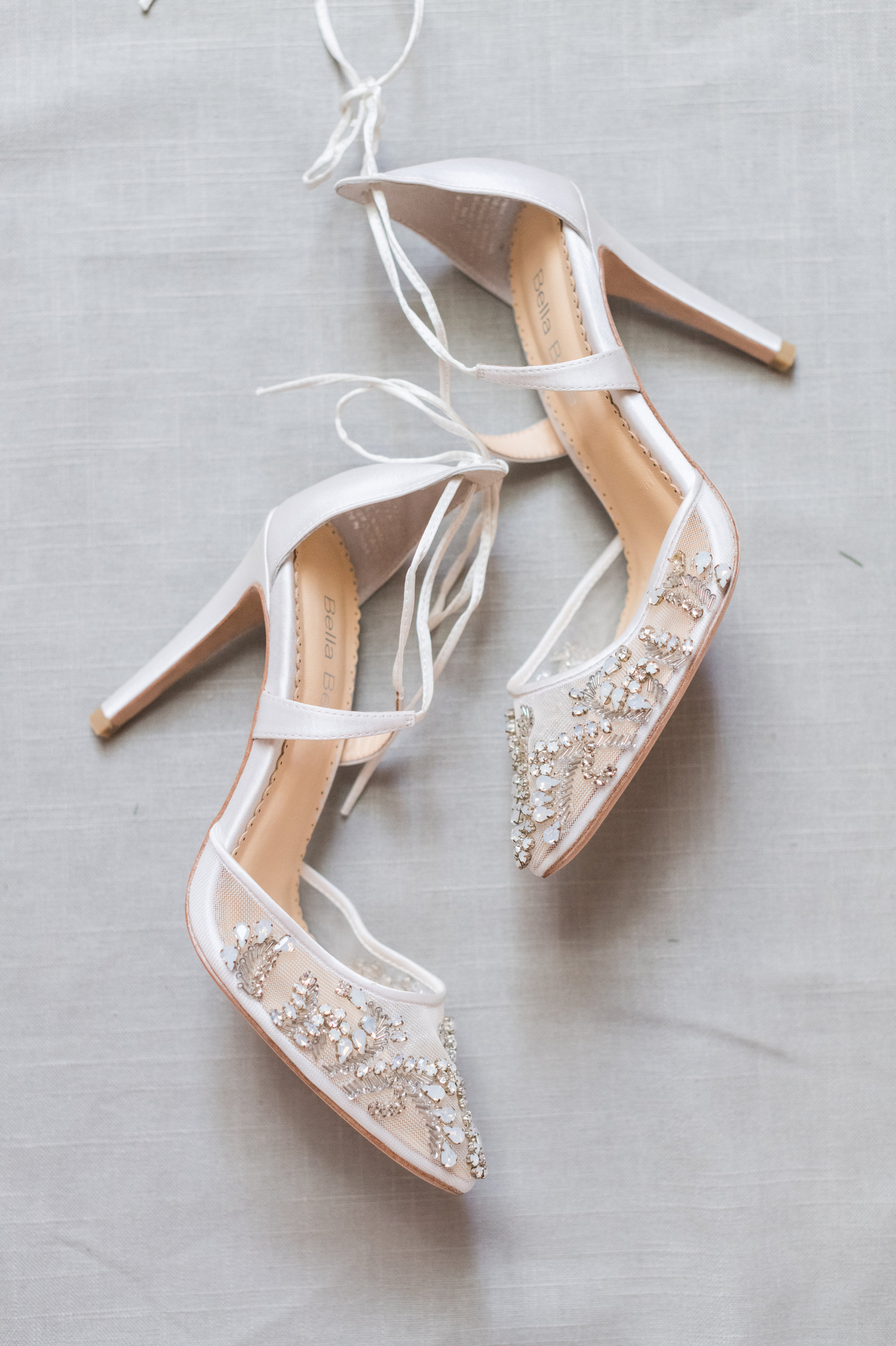 Details of bridal shoes laying on a table