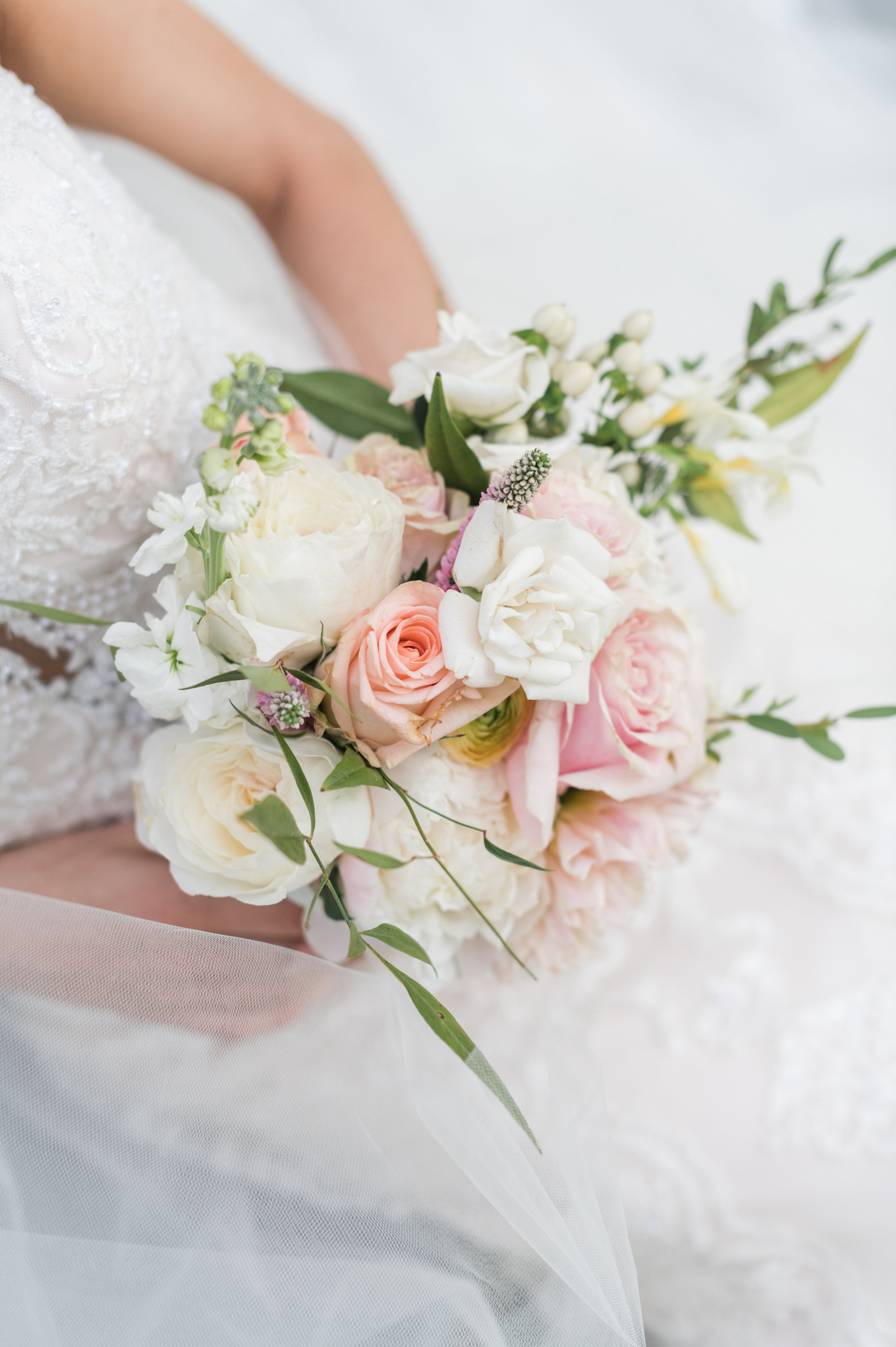 A look down to a bride's pink and white bouquet in her hands at Magnolia Hill Farm