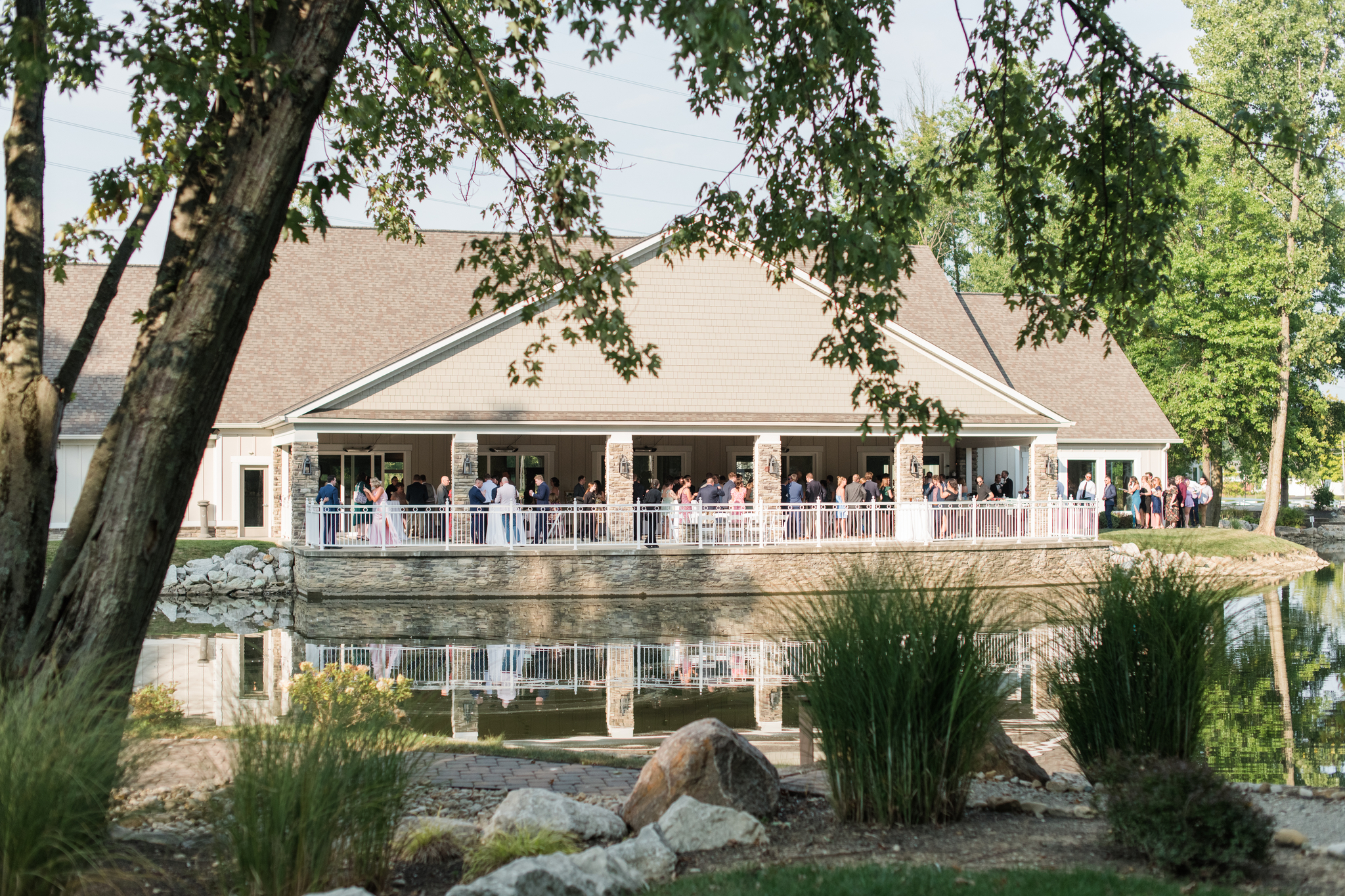 A look from across the pond of a wedding cocktail hour at the Swan Lake Event Center