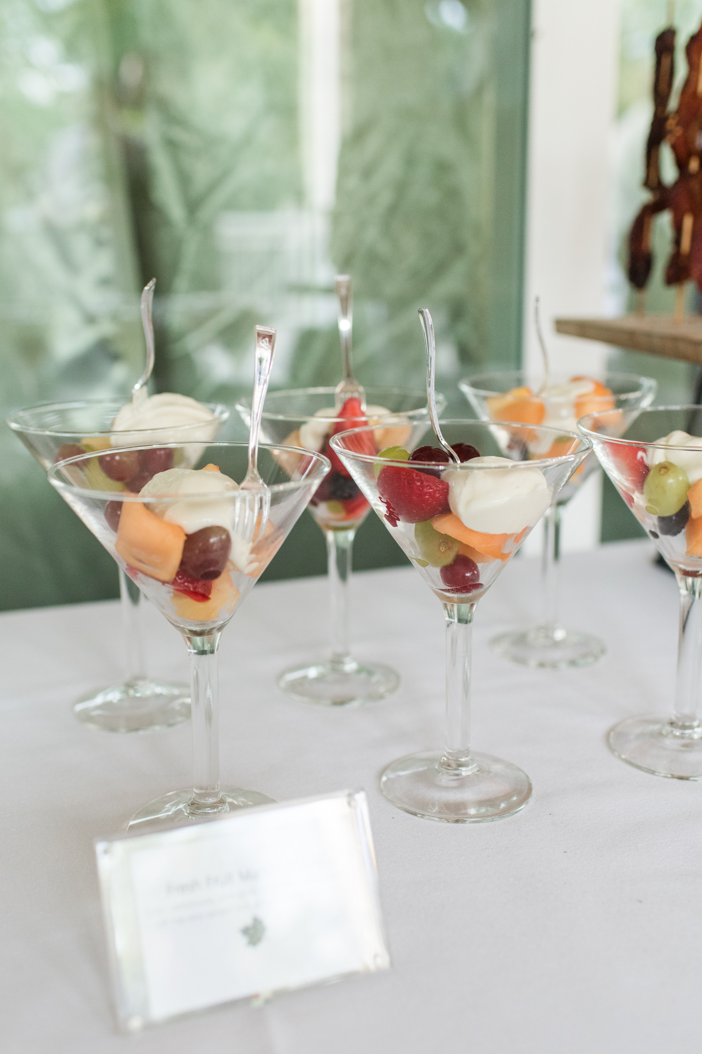 Details of fruit cocktails on a table in martini glasses