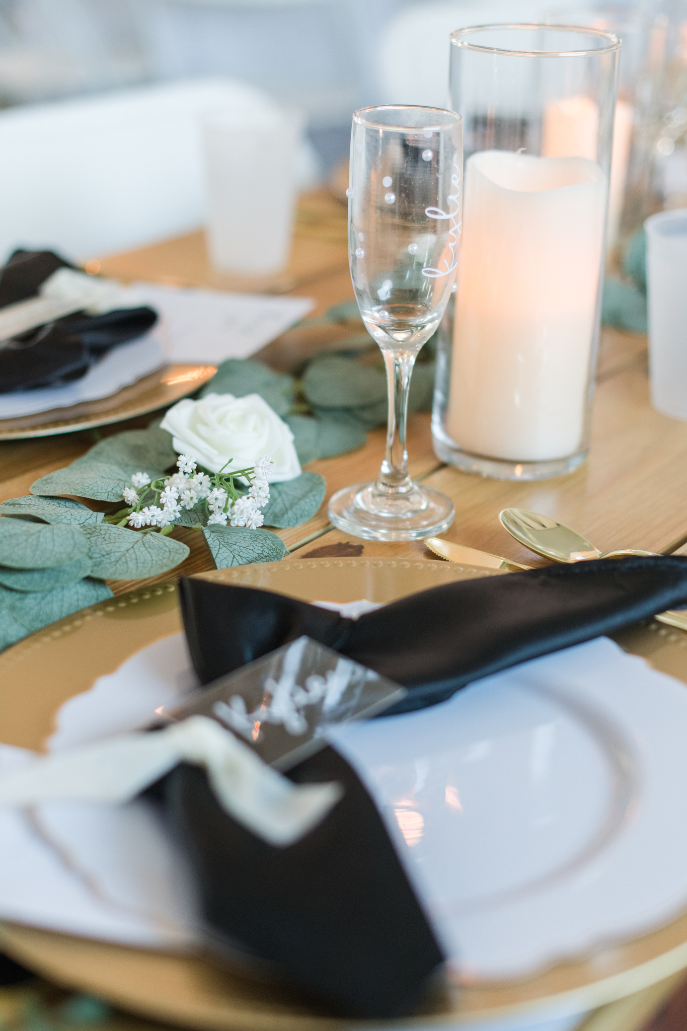 Details of a table setting on a wooden table for a White Rose Barn wedding reception